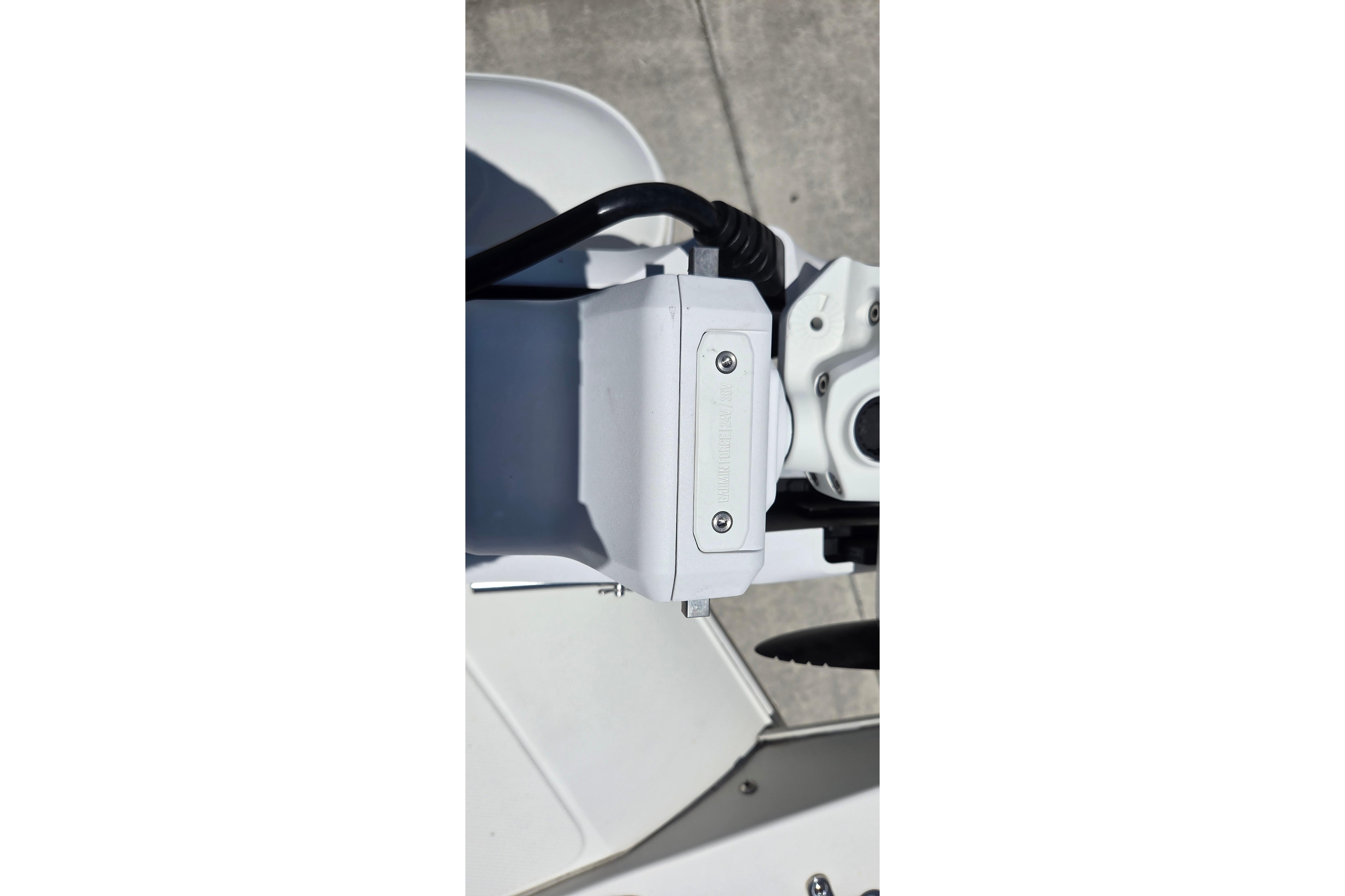 Close-up of a 2022 World Cat 255 DC boat component, featuring a white mechanical part.
