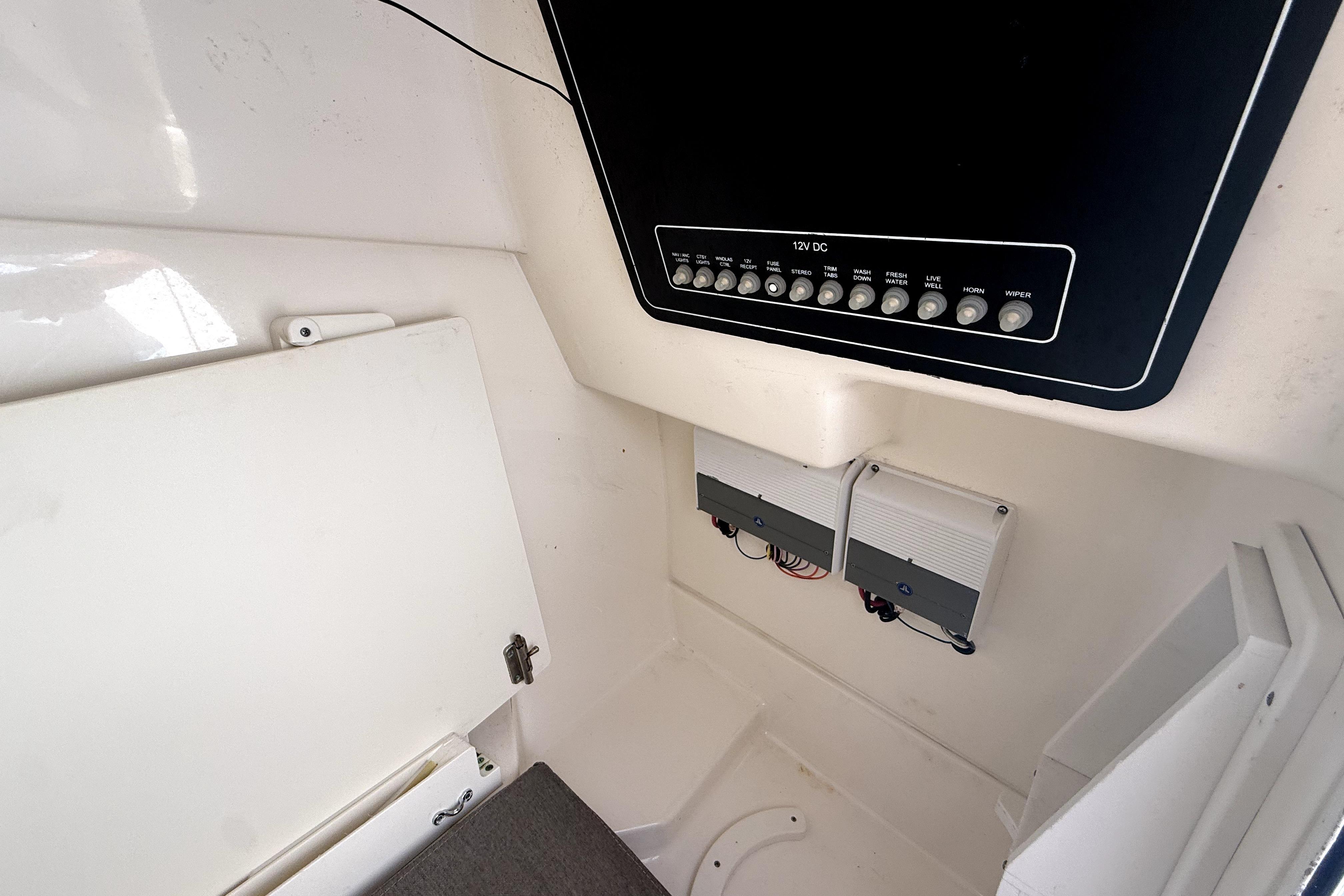 Interior view of a 2018 Boston Whaler 230 Vantage boat's control panel and storage area.