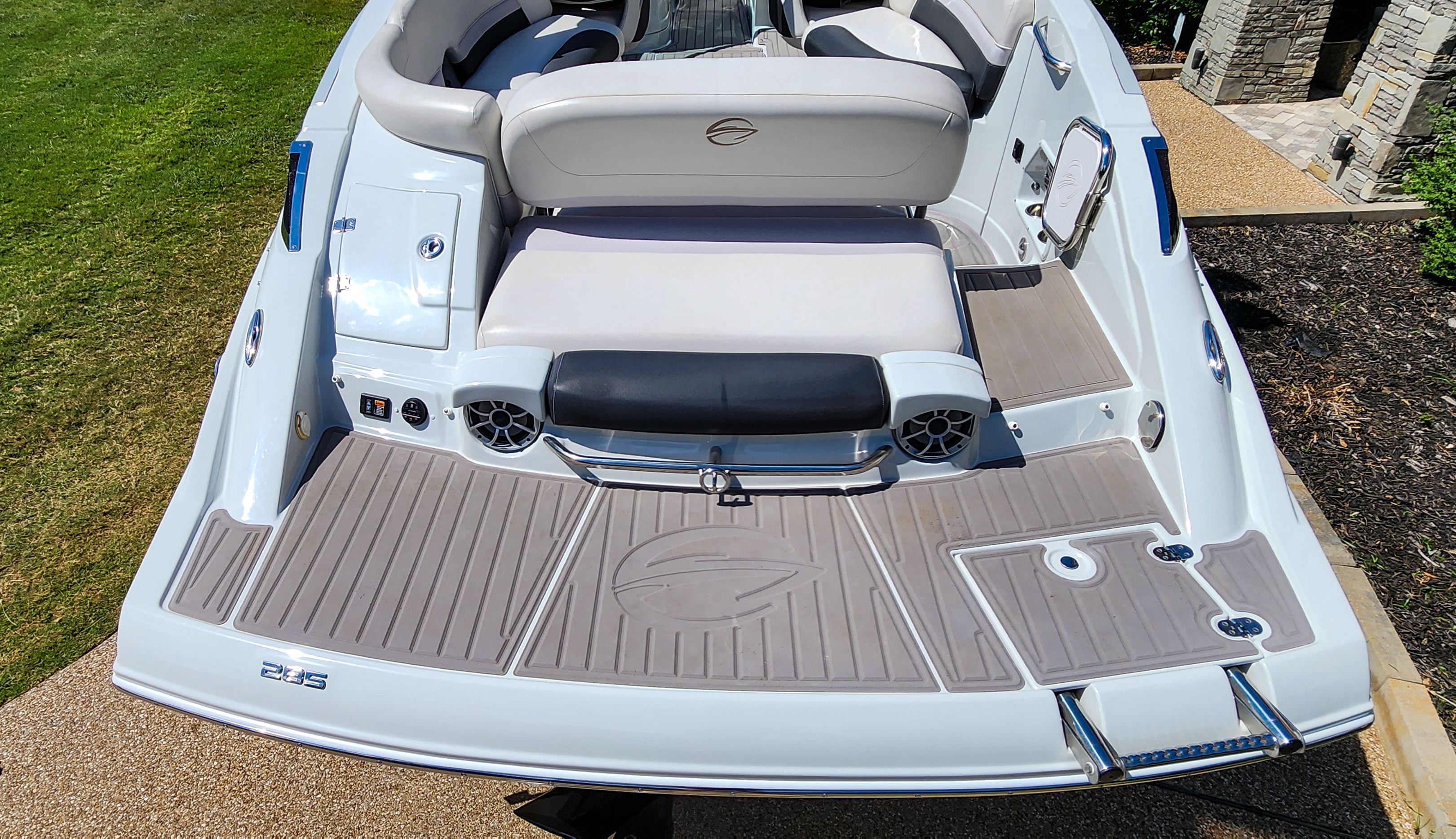 The image shows the stern of a 2017 Crownline 285SS boat with a gray deck and white seating.