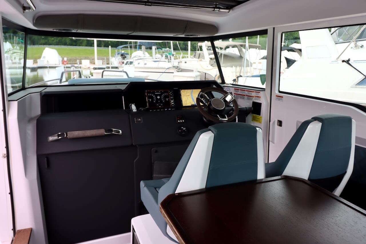 Interior of 2022 Axopar 37 XC Cross Cabin with modern dashboard and seating.