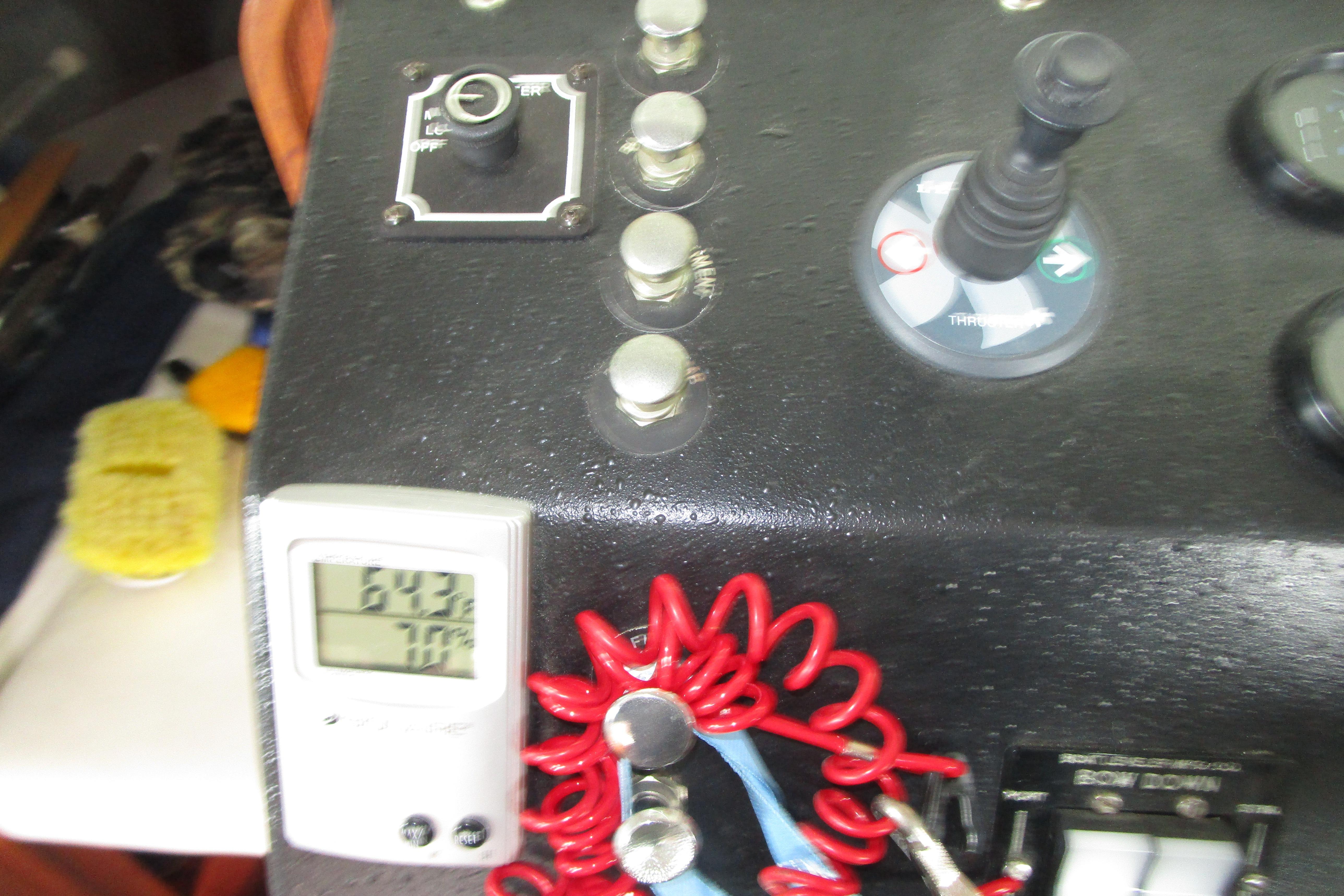 Control panel of a 1984 Tollycraft 26 Sedan boat with digital display and switches.