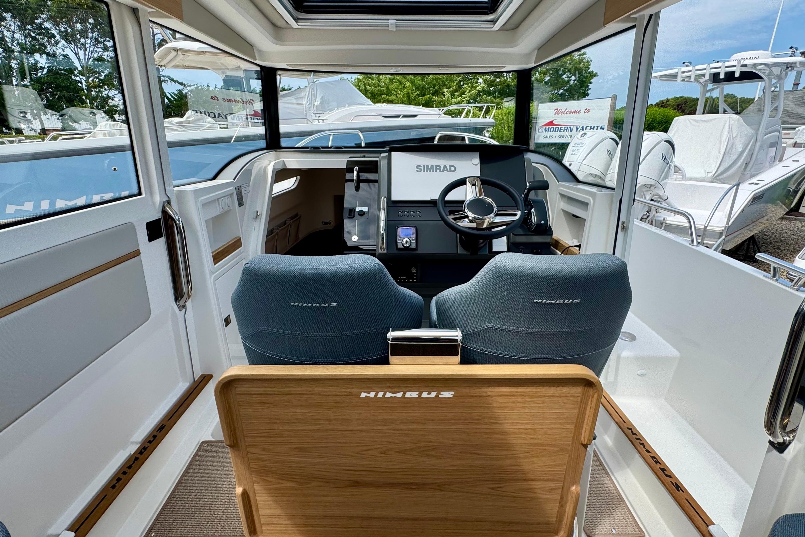 Interior of a Nimbus Commuter 9 with two seats and a modern helm station.