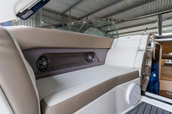 2016 Regal 28 Express boat interior with cushioned seating and built-in speakers.