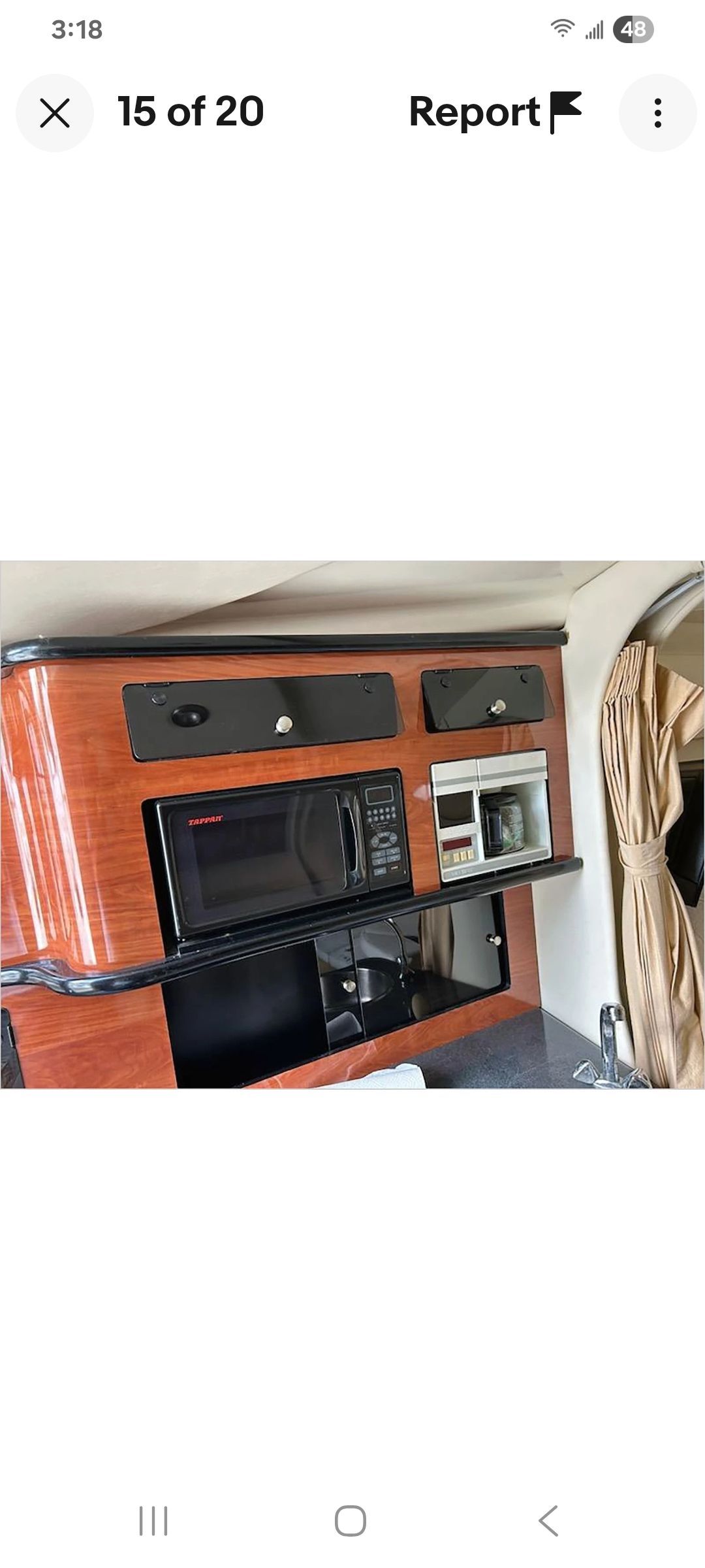 Galley area of a Monterey 290 Cruiser with microwave and cabinets.