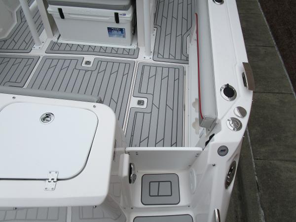 2025 Solara S-250 CW boat deck with gray non-slip flooring and storage compartments.