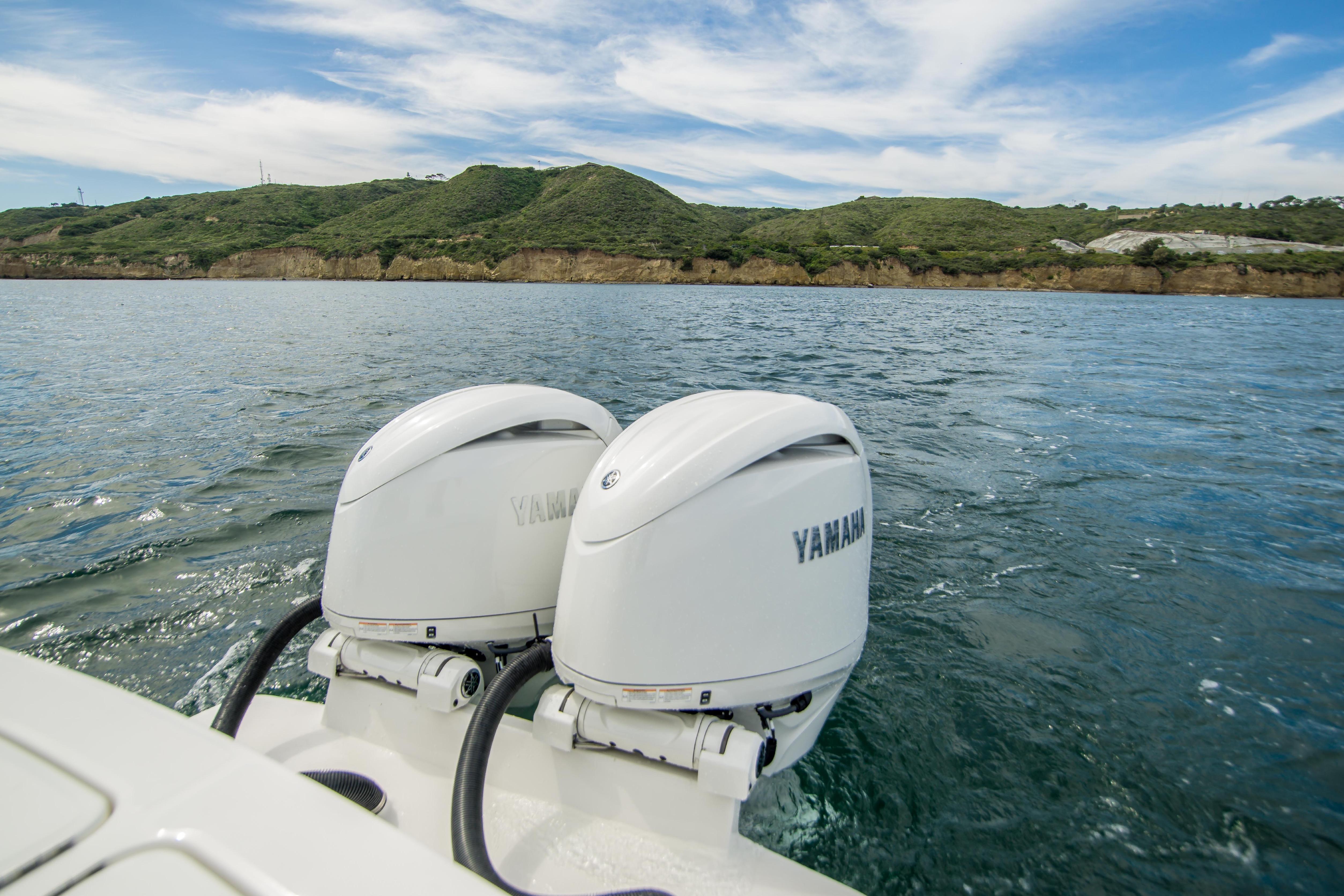 2026 Regulator 23 boat with dual Yamaha outboard engines on scenic water.