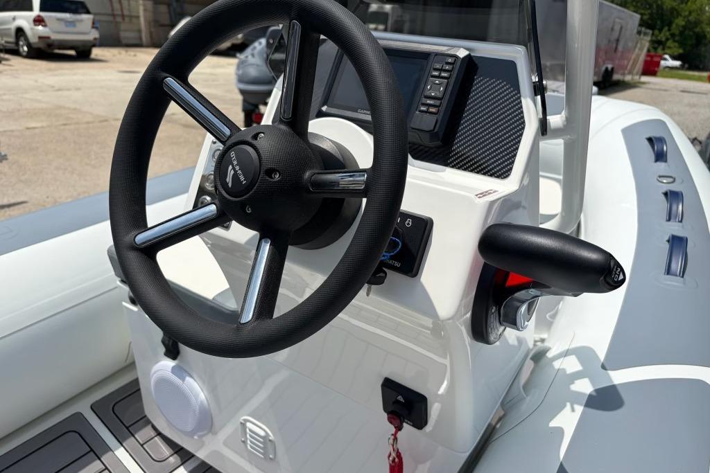 Steering console of 2026 Highfield Classic 360 boat, featuring modern controls and sleek design.