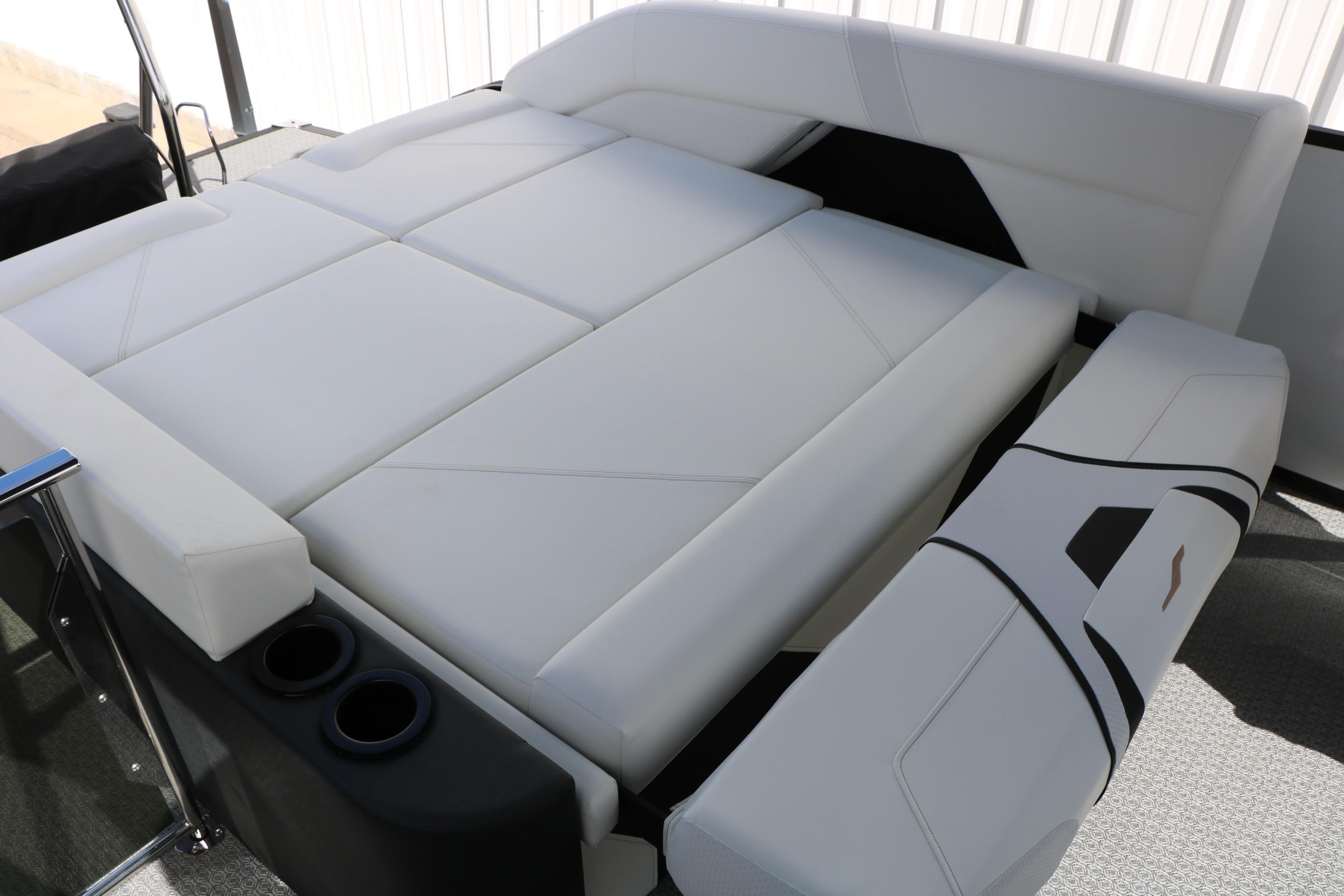 Luxurious white seating on 2026 Evotti 725 CS Tri-Toon boat, featuring cup holders.