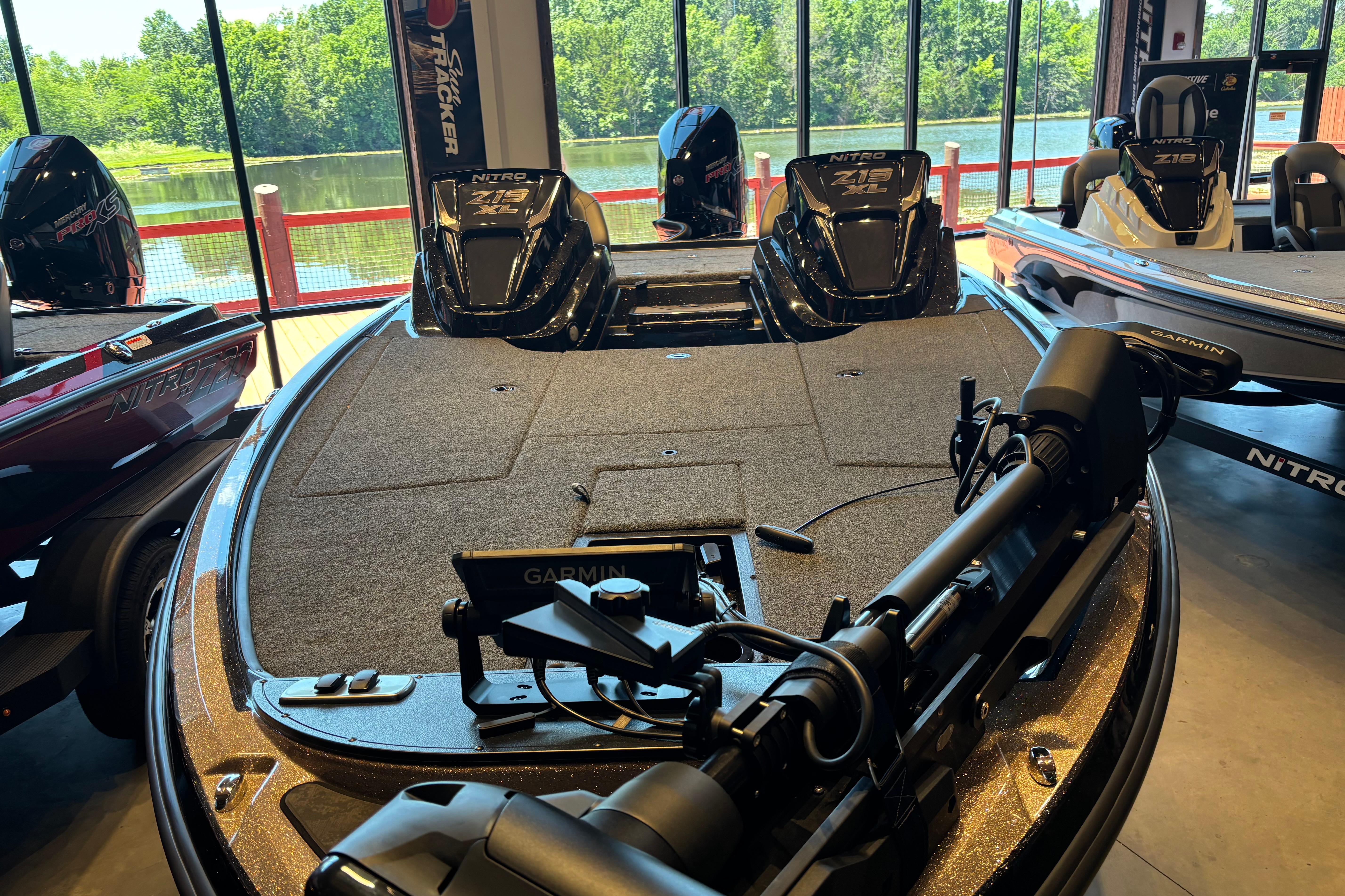 2026 Nitro Z19 XL Pro fishing boat with Garmin equipment, displayed indoors near a lake.