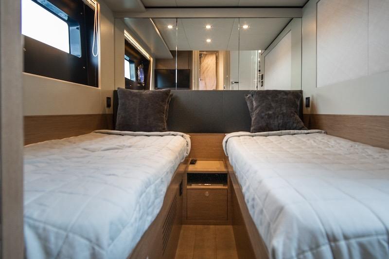 Luxurious twin cabin interior of 2023 Absolute 62 Fly yacht, featuring modern design and comfort.