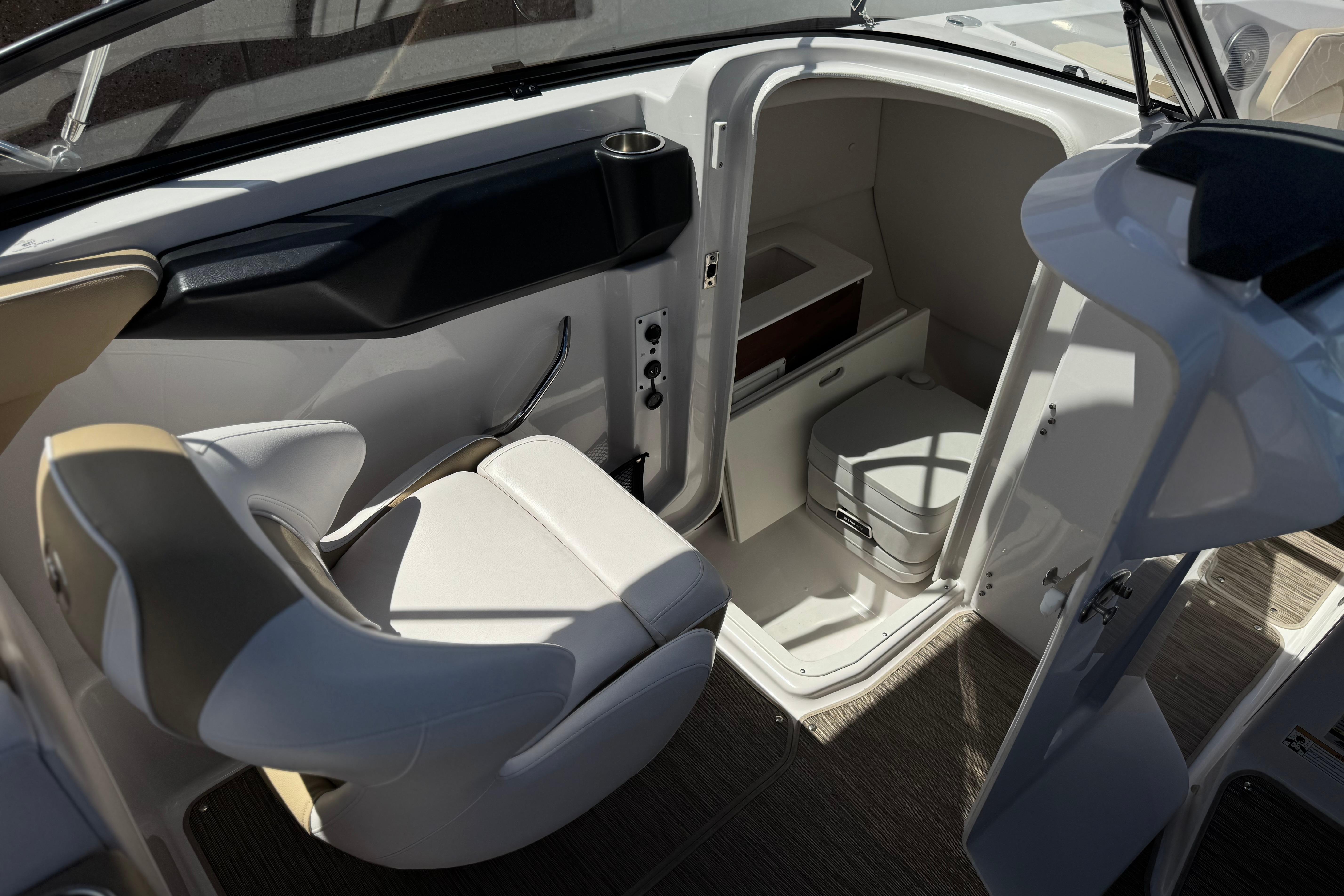 2017 Scarab 255 H.O. Platinum boat interior with seating and compact restroom.