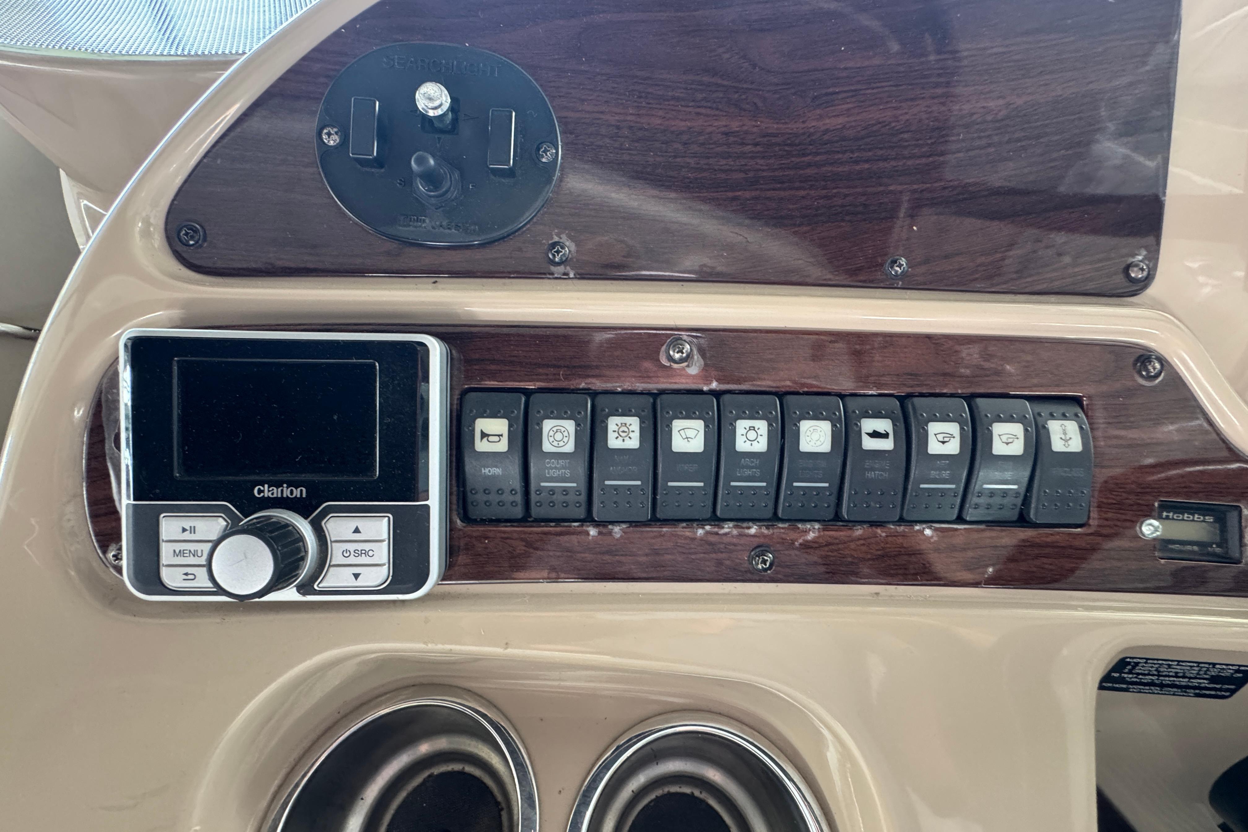 Control panel of a 2006 Chaparral 330 Signature boat with switches and Clarion audio system.