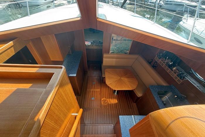 Interior of 2007 Island Pilot 395 yacht with wood finish and seating area.
