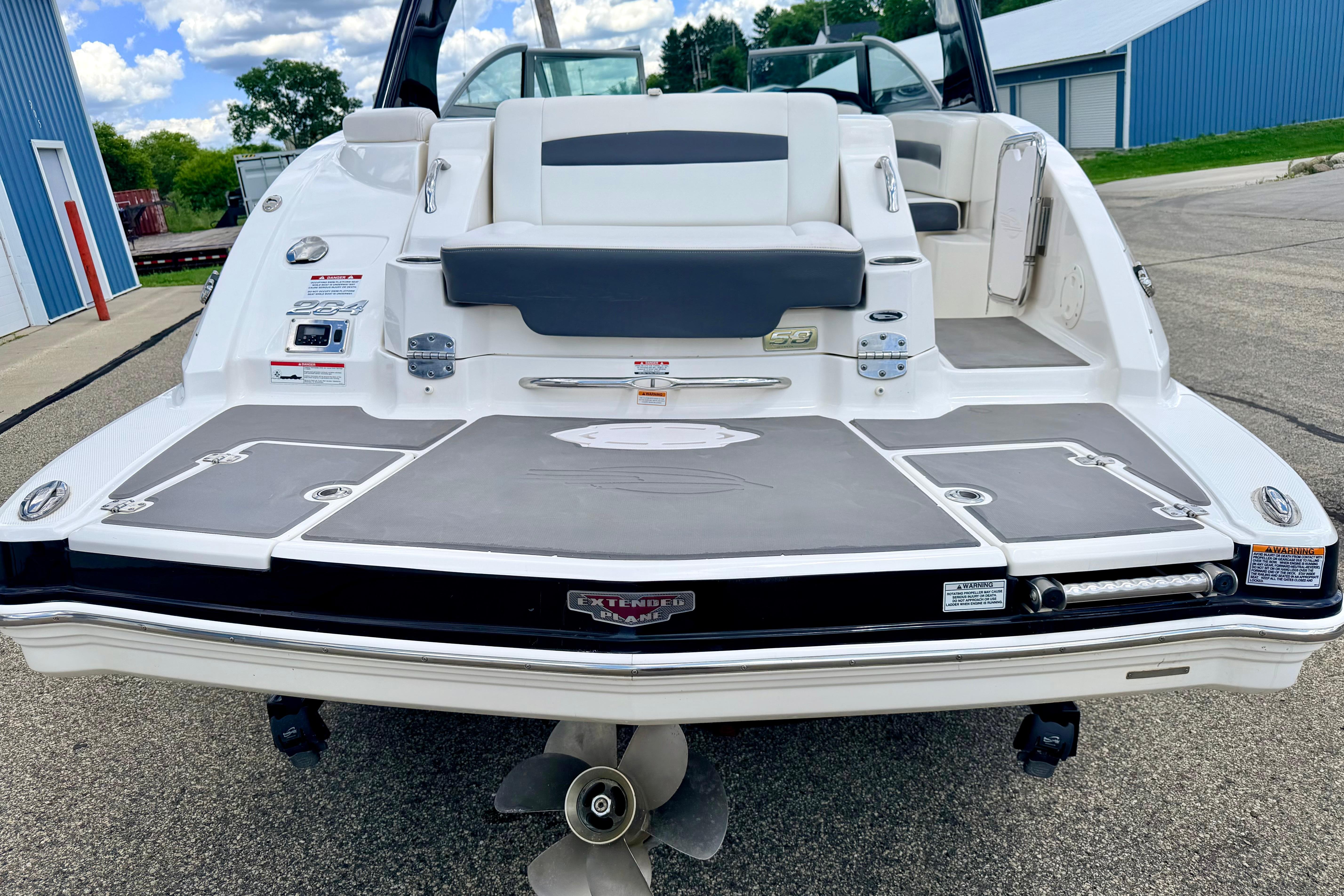 2015 Chaparral Sunesta 264 boat rear view with swim platform and seating.