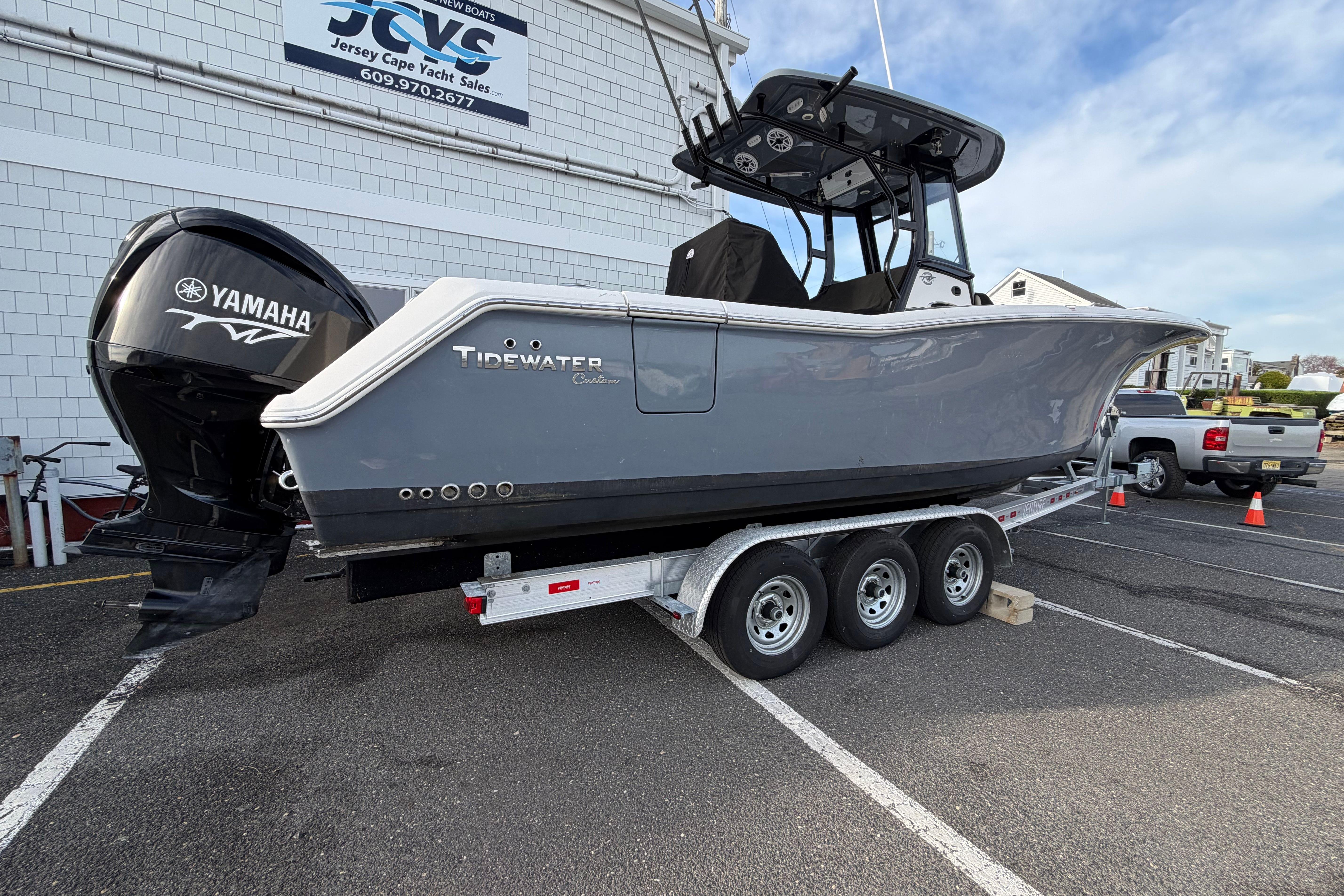 2023 Tidewater 282 CC Adventure Bluewater boat on trailer, featuring Yamaha engine.