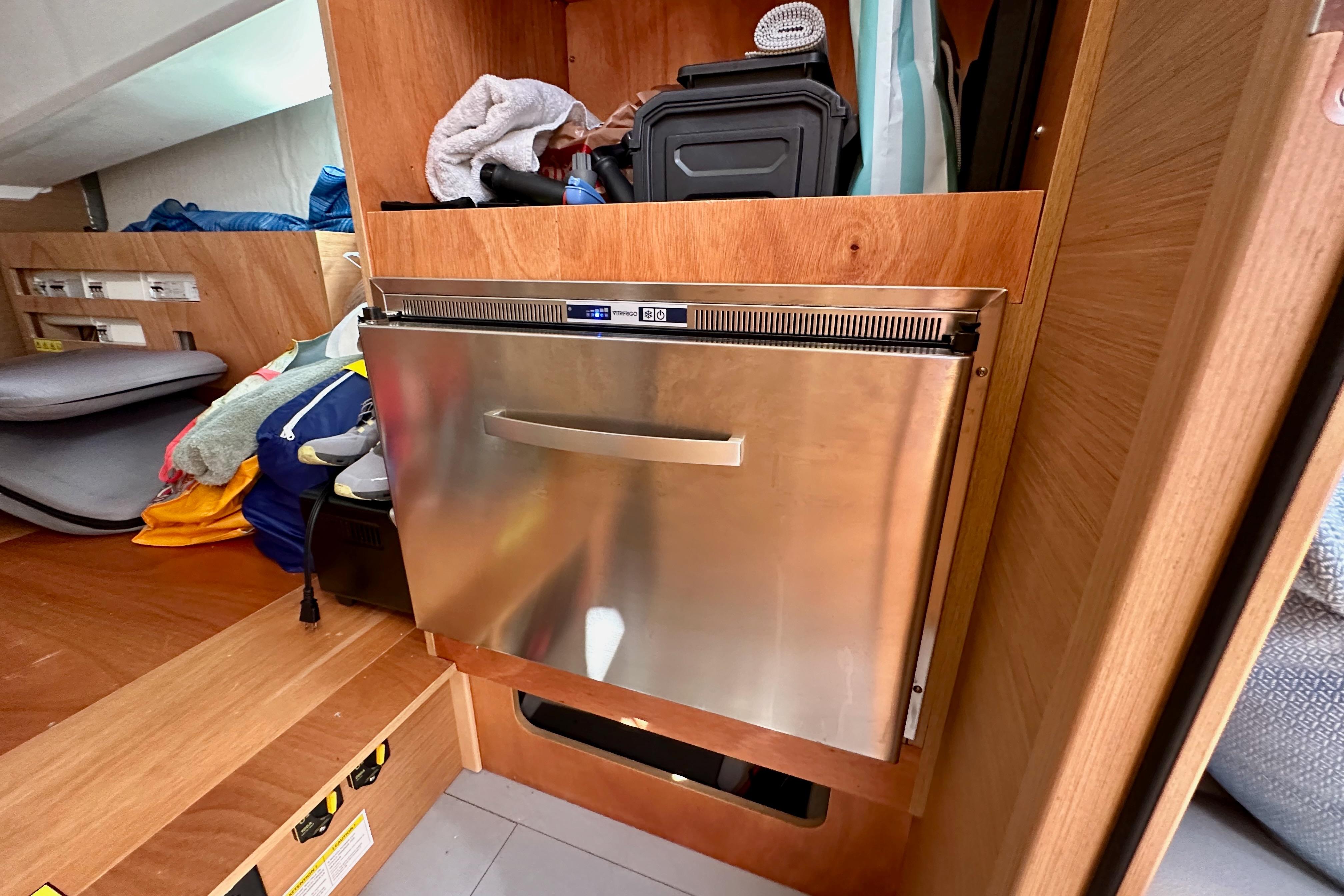 Interior of 2024 Jeanneau Sun Odyssey 410 with stainless steel appliance and storage.