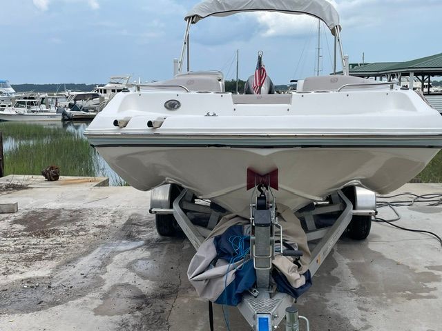 A 2018 Hurricane SS188 boat on a trailer in a marina area.