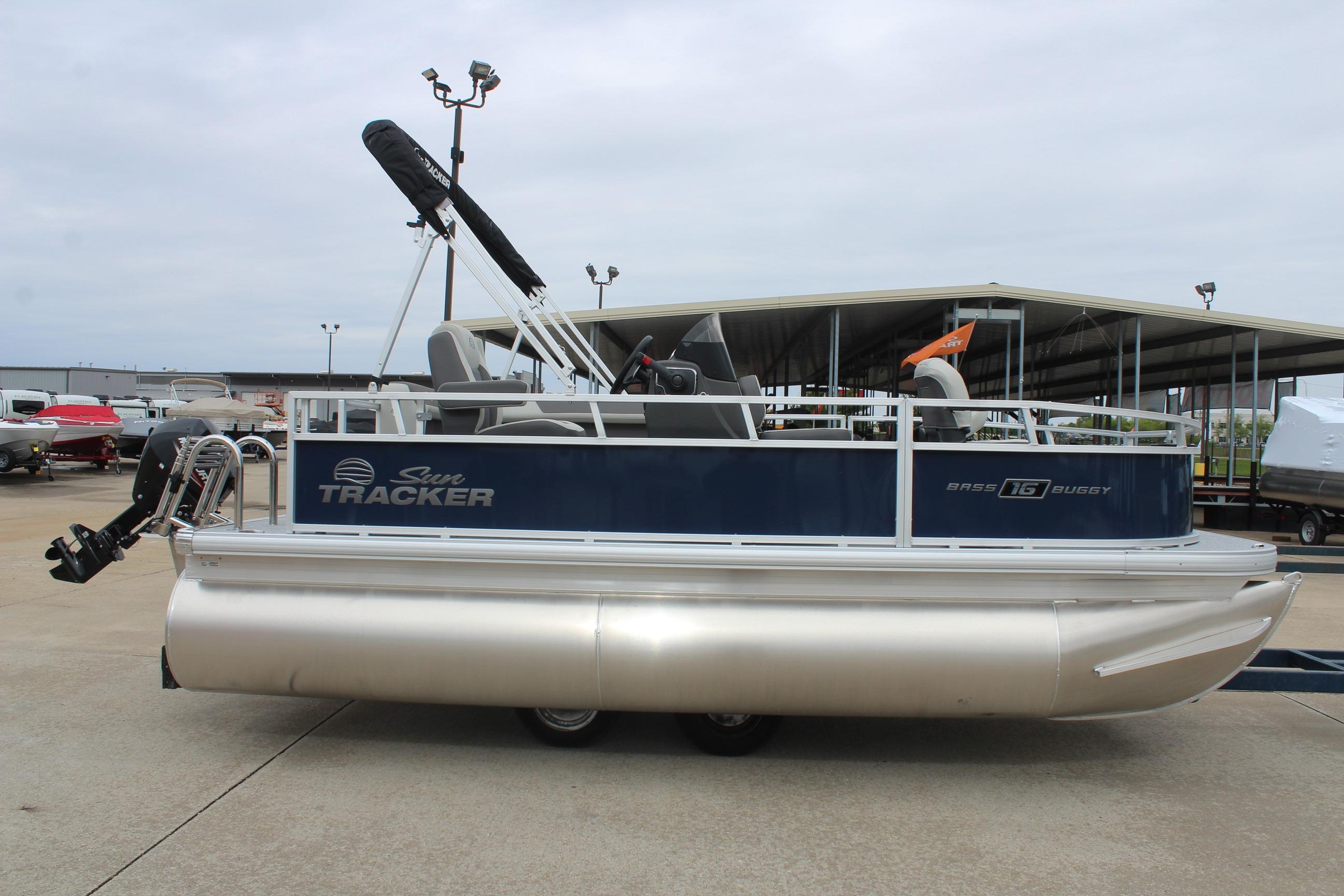 2026 Sun Tracker Bass Buggy 16 XL Select pontoon boat in marina setting.