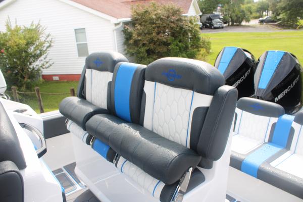 2024 Fountain 34 SC boat seats with blue and white upholstery, featuring Mercury engines.