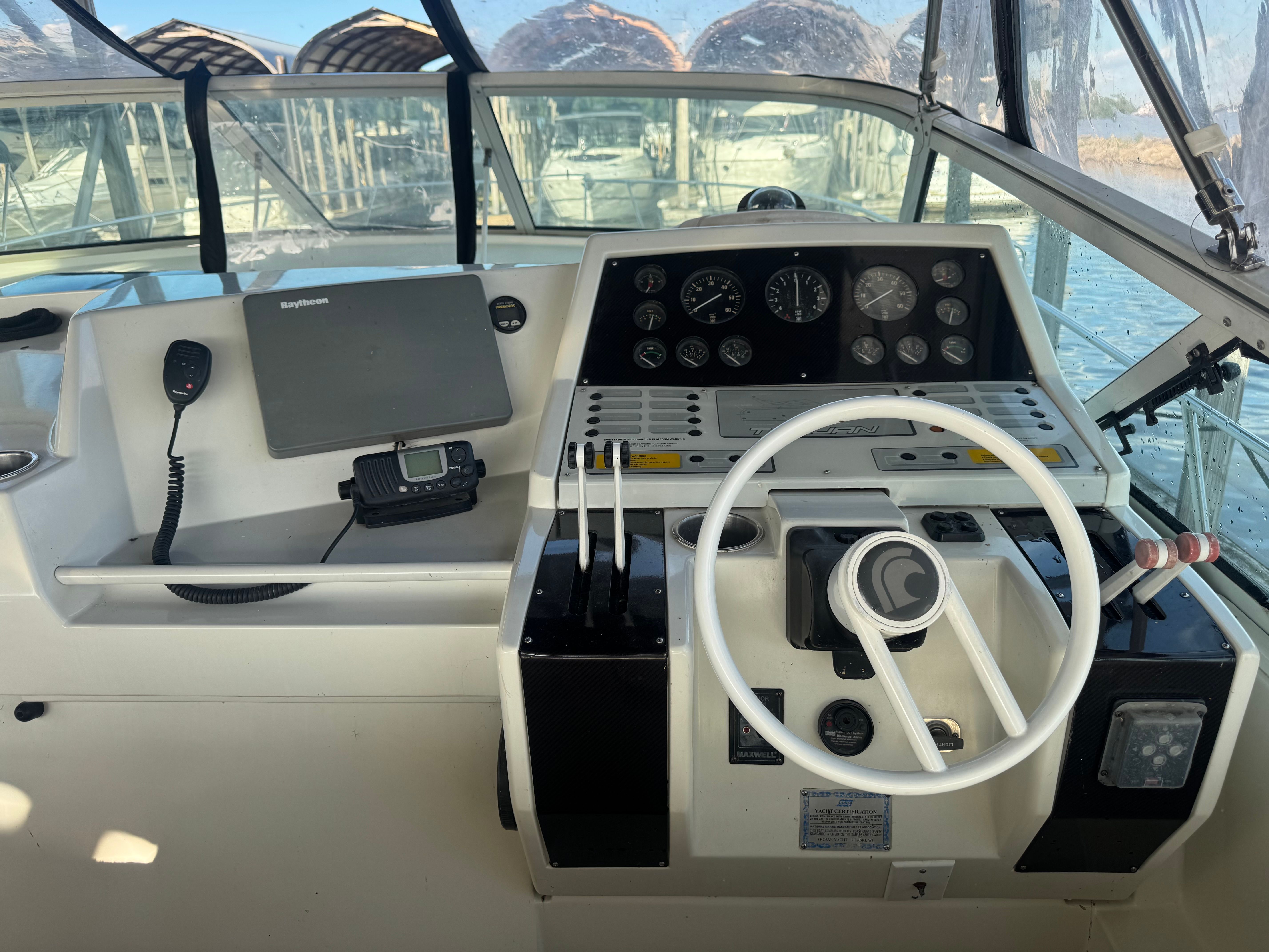 The cockpit of a 1995 Trojan 390x with steering wheel, instruments, and navigation system.