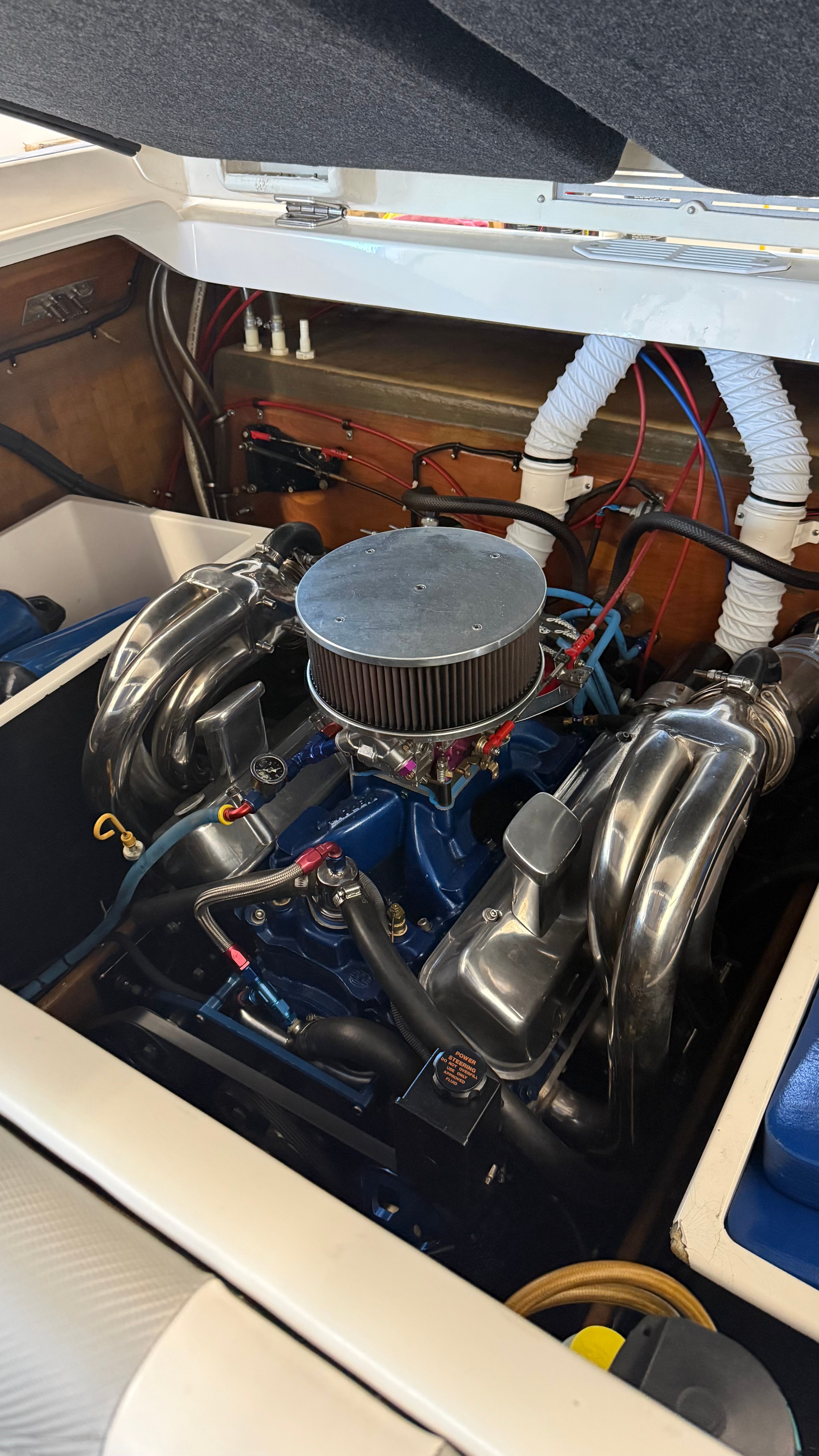 Engine compartment of a 1999 Lavey Craft 2950 NuEra with shiny metal components.