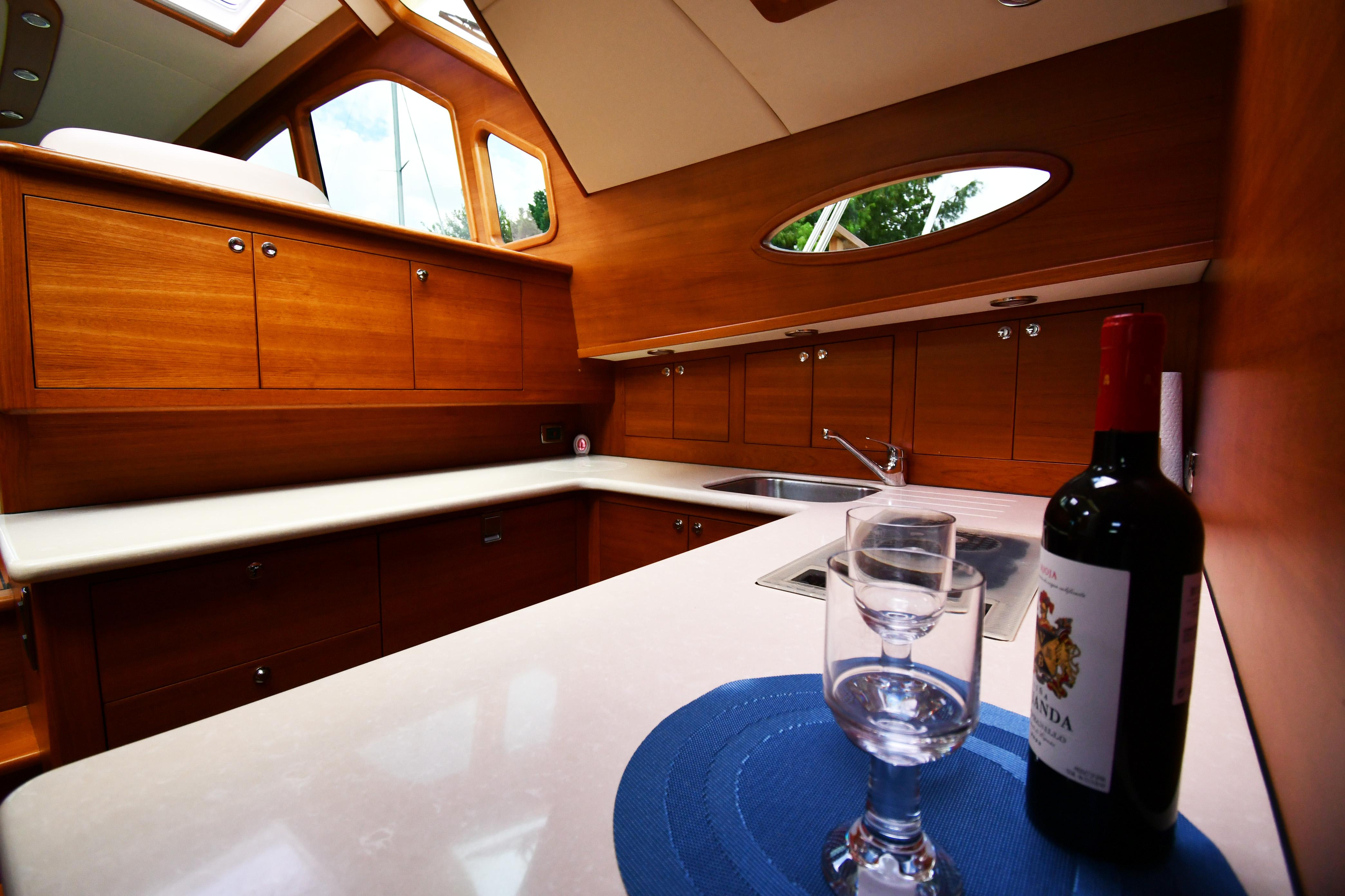 Luxurious 2020 Palm Beach Motor Yachts PB52 interior with elegant wood cabinetry and wine setup.