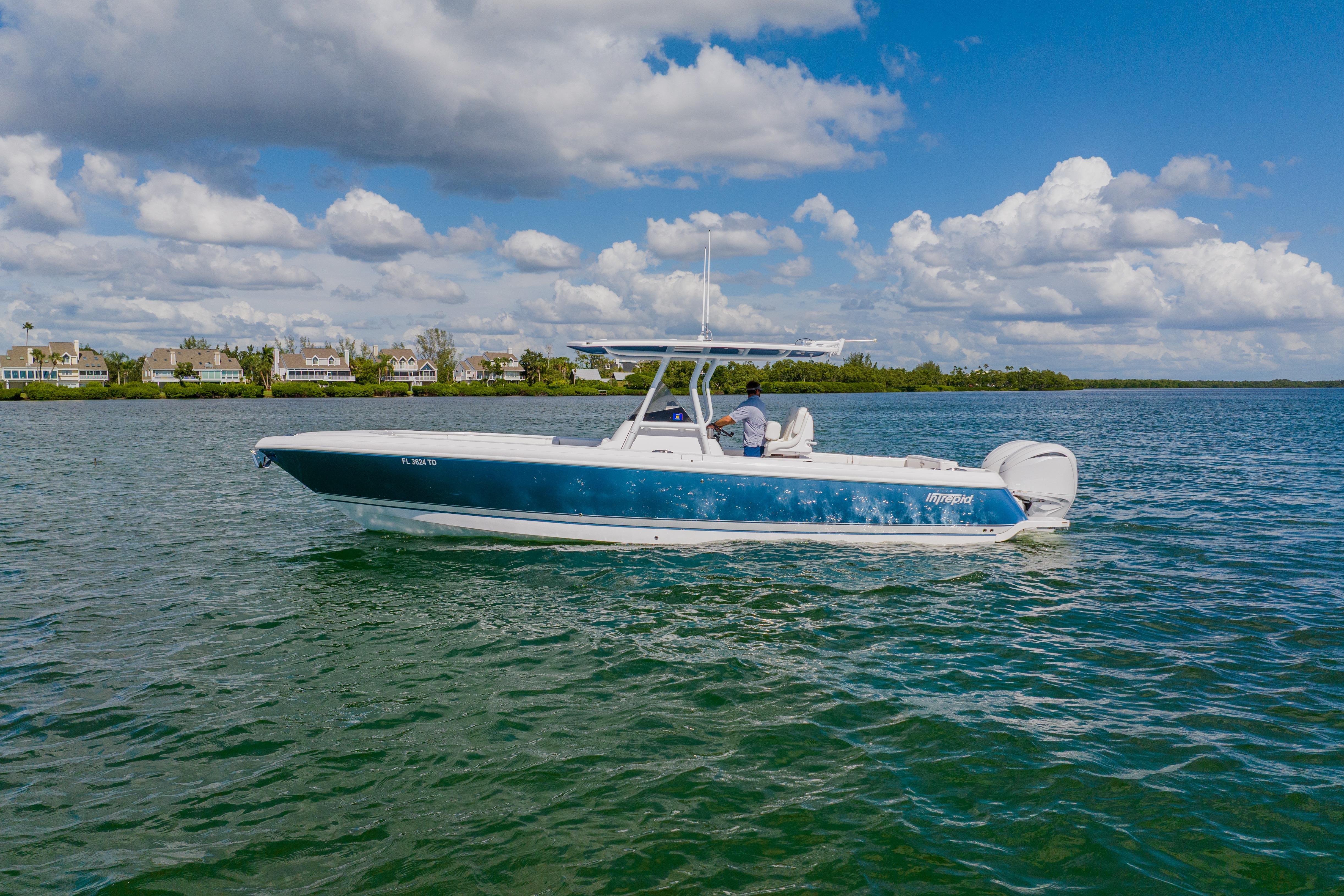 2018 Intrepid 327 Center Console boat cruising on a sunny day.