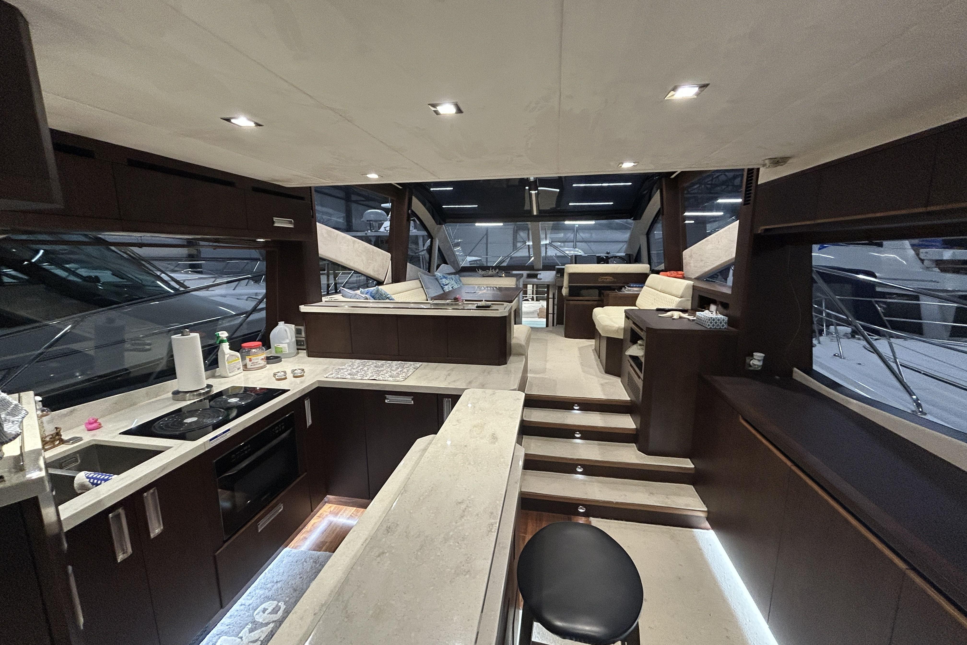Luxurious interior of 2018 Galeon 560 Sky yacht with modern kitchen and seating area.