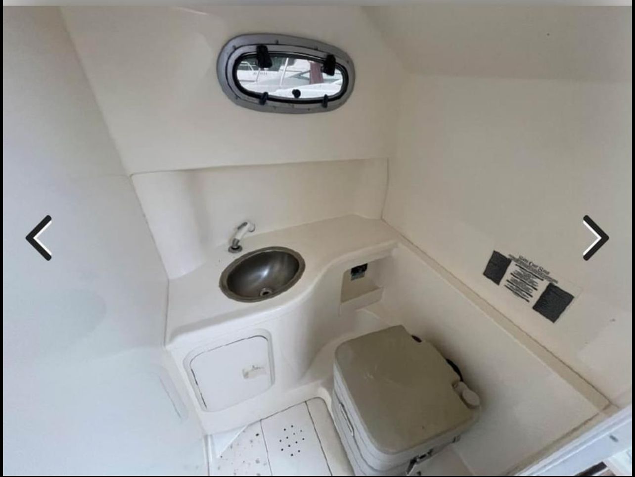 Interior of 2001 Boston Whaler 26 Conquest with sink and toilet.