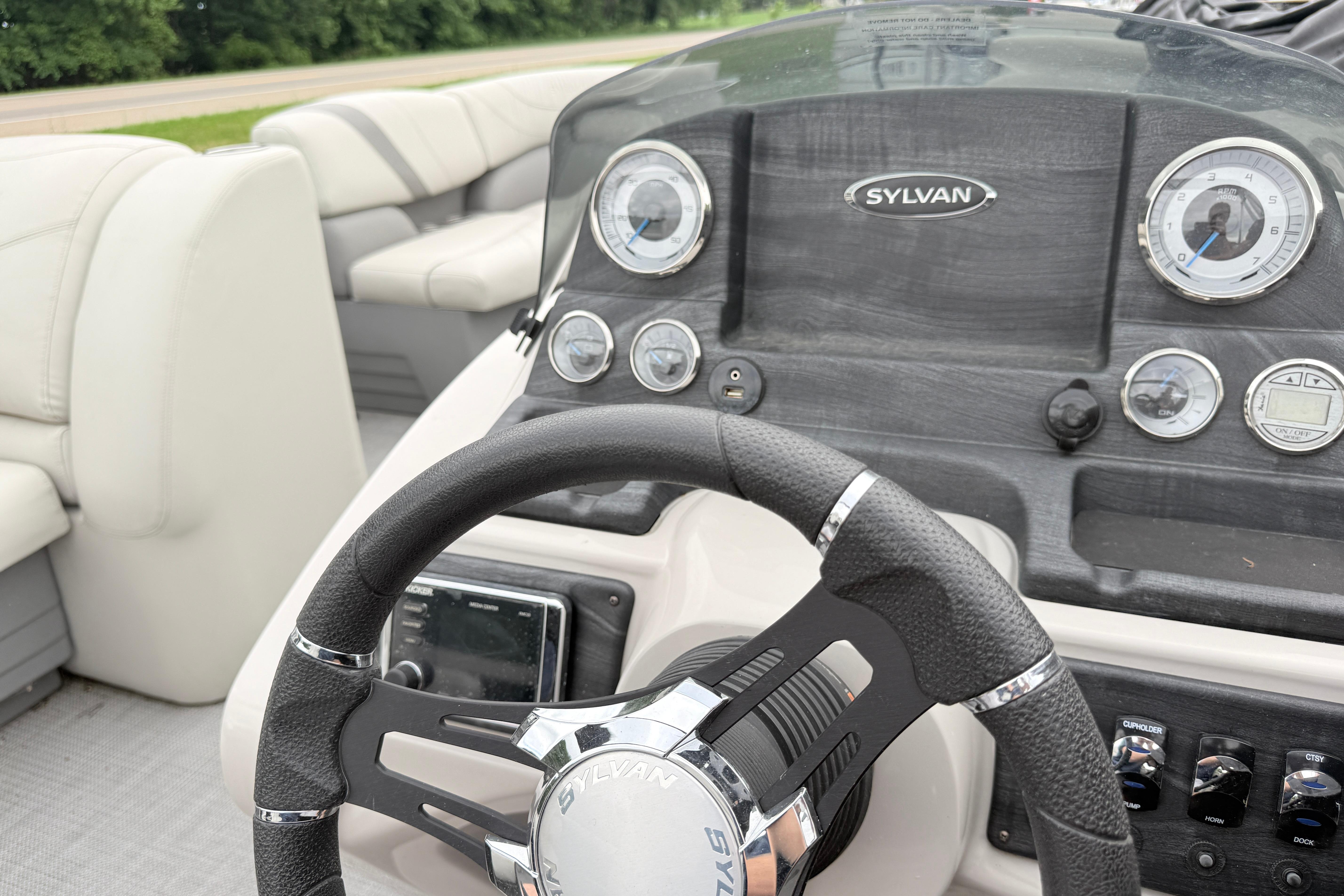 2019 Sylvan 8522 Mirage Signature F-n-C boat dashboard with steering wheel and gauges.