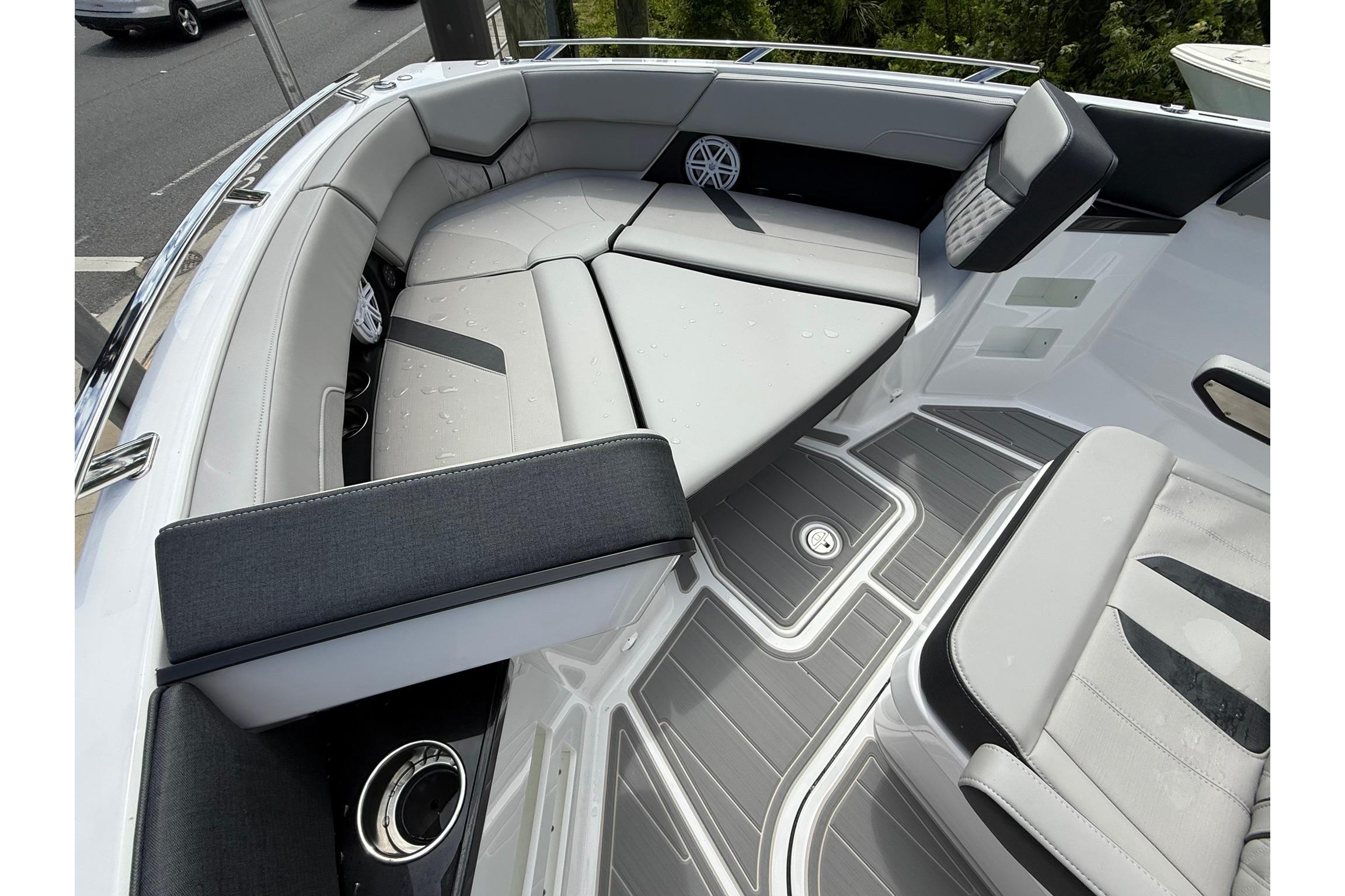 Luxurious seating area on the 2027 Monterey Elite 30 OB boat, featuring sleek design and comfort.