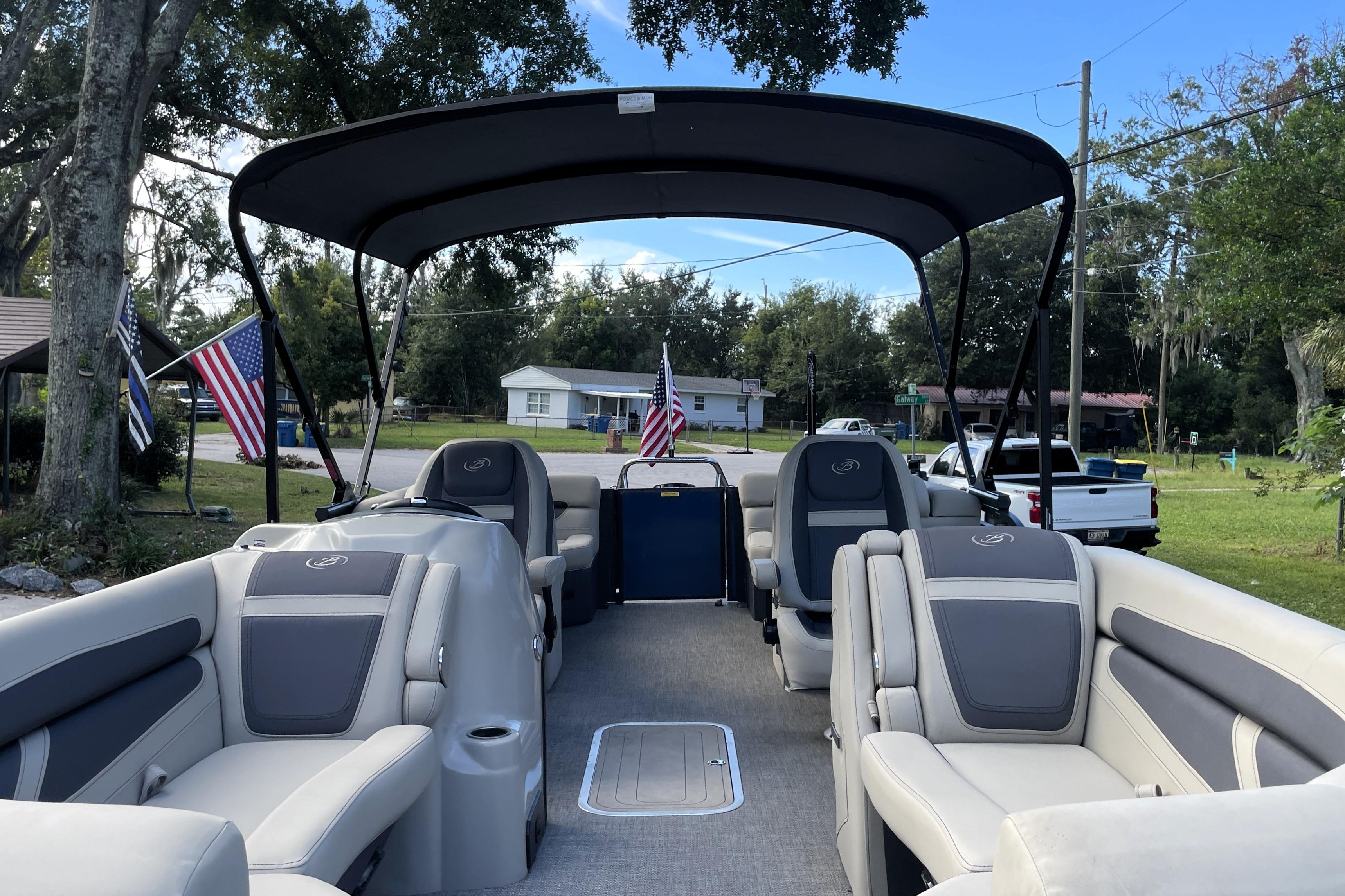 2022 Barletta Cabrio 22QC pontoon boat with spacious seating and canopy in a residential area.