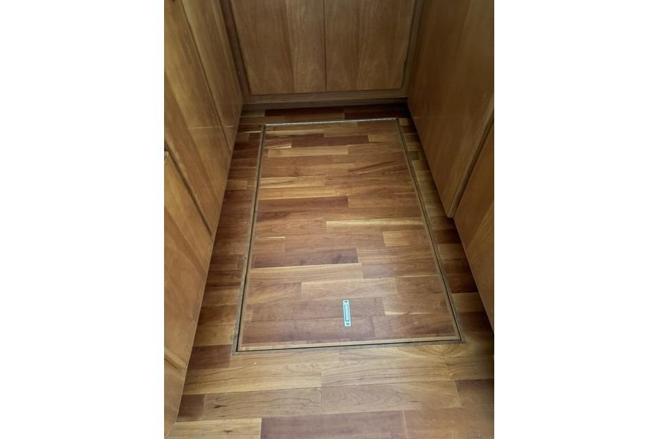 Wooden floor hatch in a 2007 Navigator 5100 yacht interior.