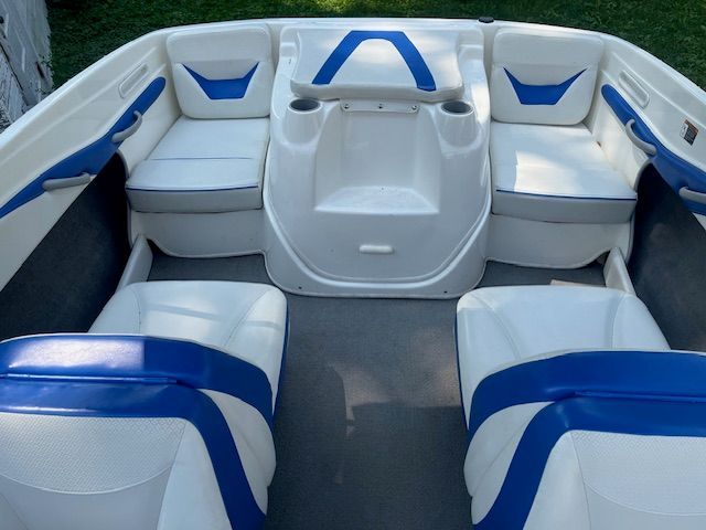 Interior of a Bayliner 185 boat with blue and white seating.