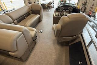 2022 Sun Tracker Fishin' Barge 22 DLX interior with plush seating and modern helm.