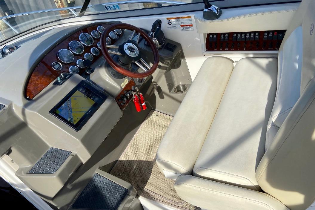 Cockpit of 2012 Regal 35 Express Cruiser with steering wheel and navigation display.