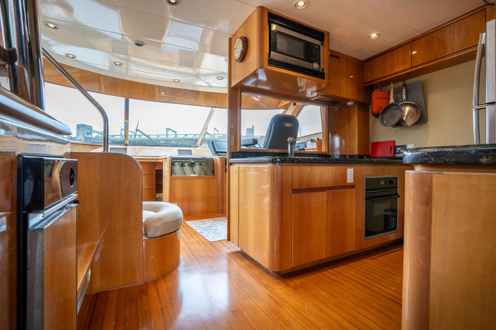 Luxurious interior of 1999 Vitech 68' Pilothouse yacht with modern kitchen amenities.