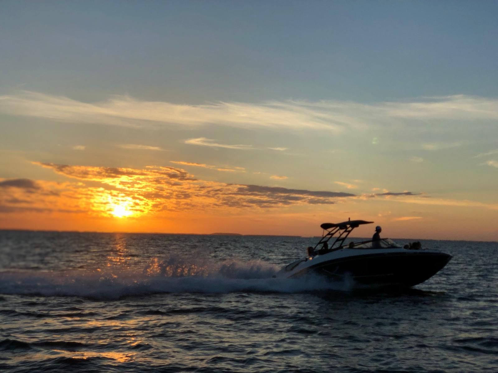 2016 Yamaha AR240 boat cruising at sunset on the ocean.