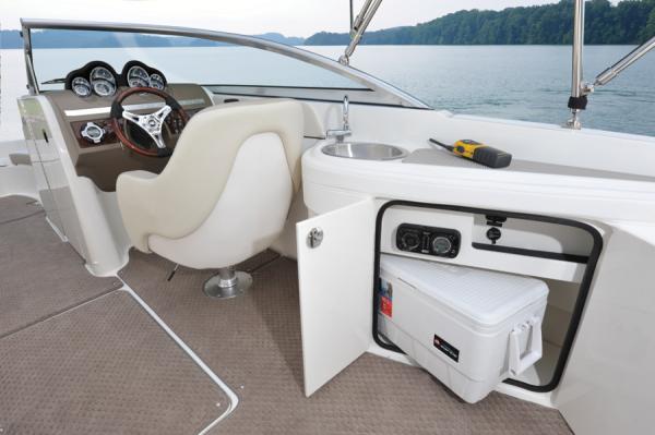 Manufacturer Provided Image: 2013 Sea Ray 260 Sundeck interior with captain's chair, sink, and storage compartment.
