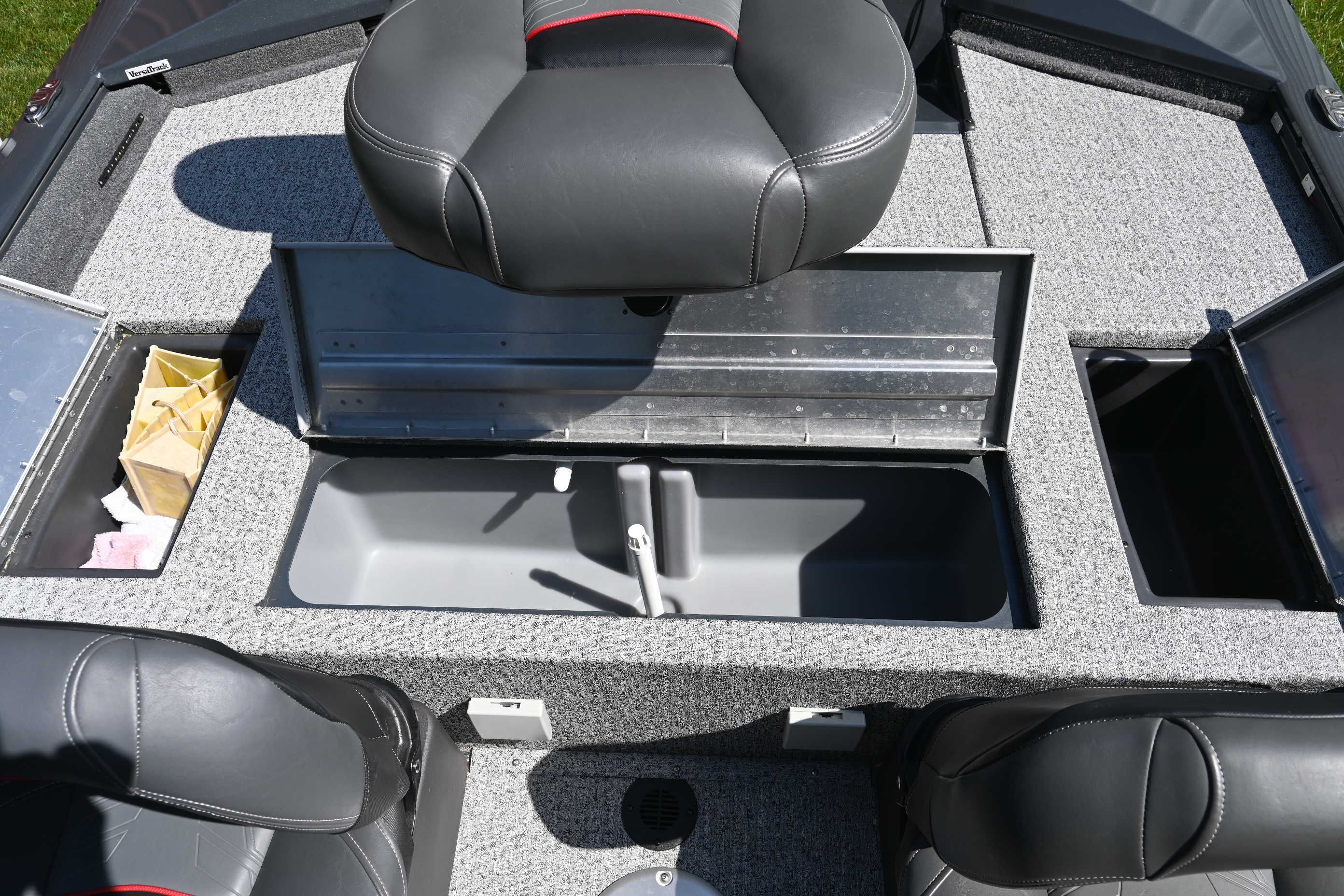 Interior view of a Tracker Pro 175 TF boat with gray carpeting and black seats.
