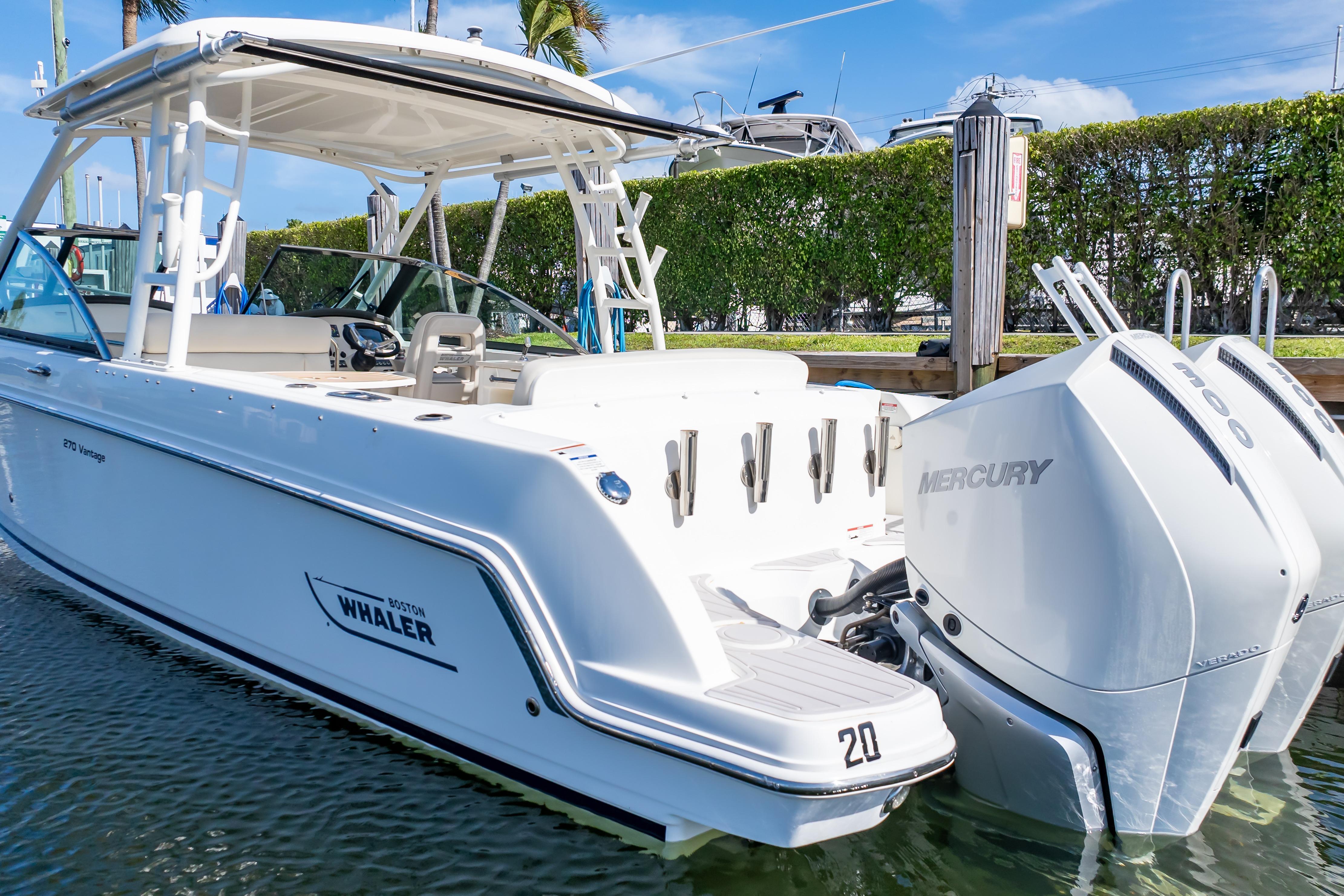 2019 Boston Whaler 270 Vantage boat with dual Mercury engines docked in marina.