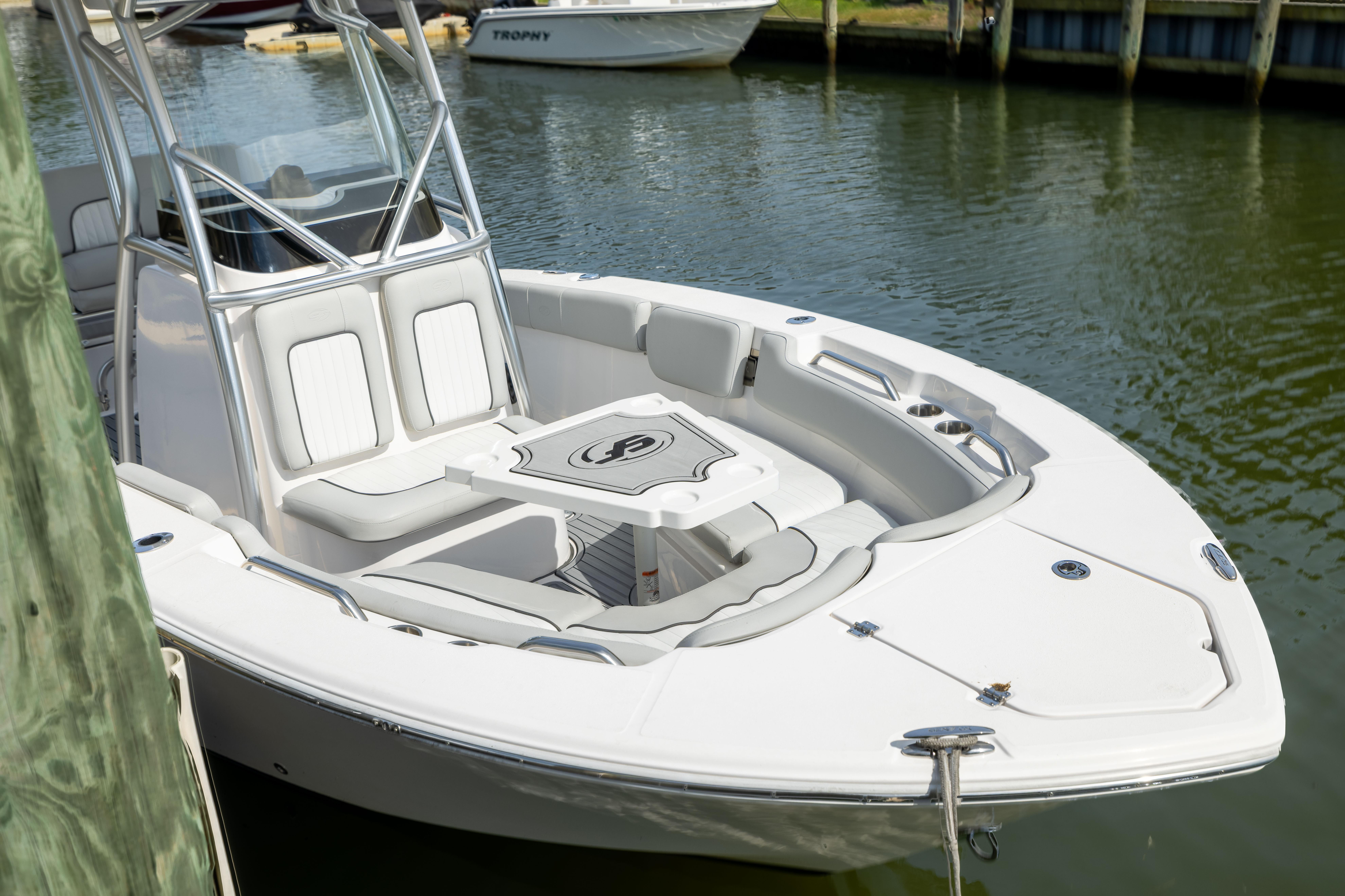 2023 Sea Fox 228 Commander boat docked, featuring sleek design and spacious seating.