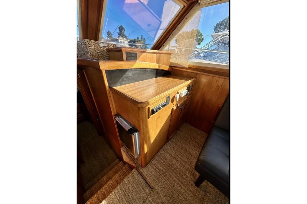 1985 Egg Harbor 33 Sedan interior with wooden cabinetry and navigation equipment.