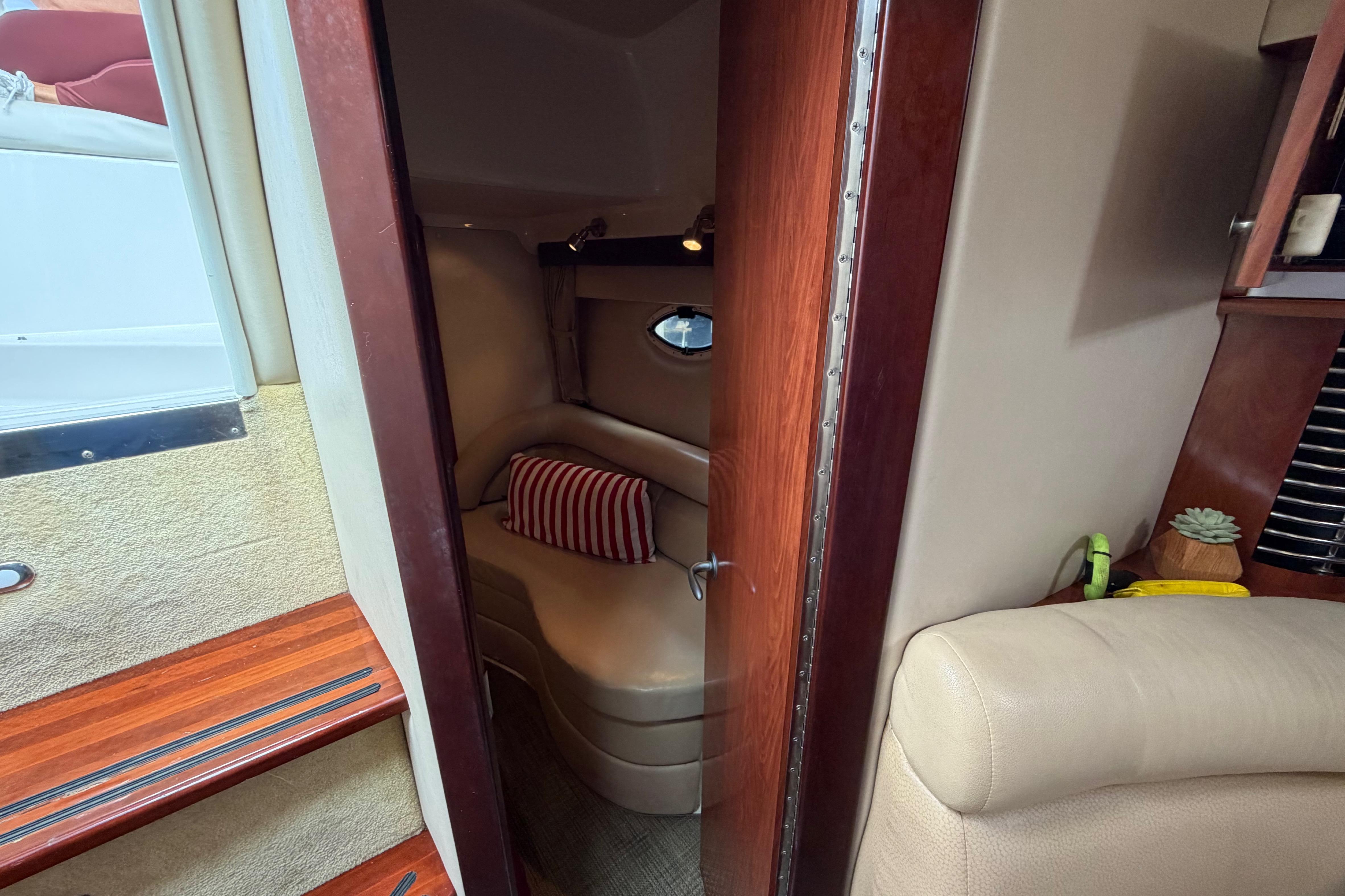 Interior cabin of 2007 Monterey 350 Sport Yacht with cozy seating and striped pillow.