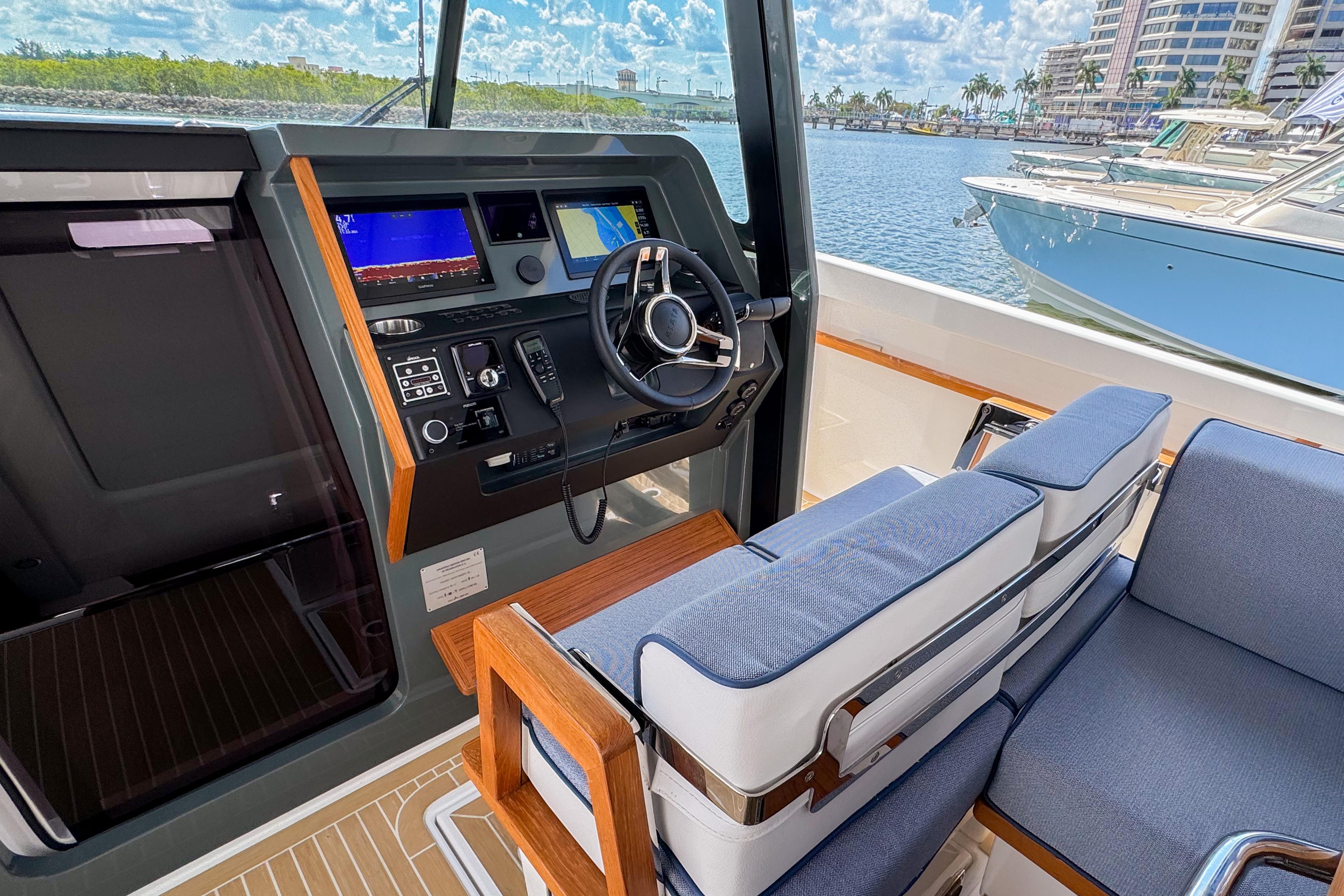 Interior of 2025 Aiata Wayfinder 38 Cabin boat with modern helm and seating.