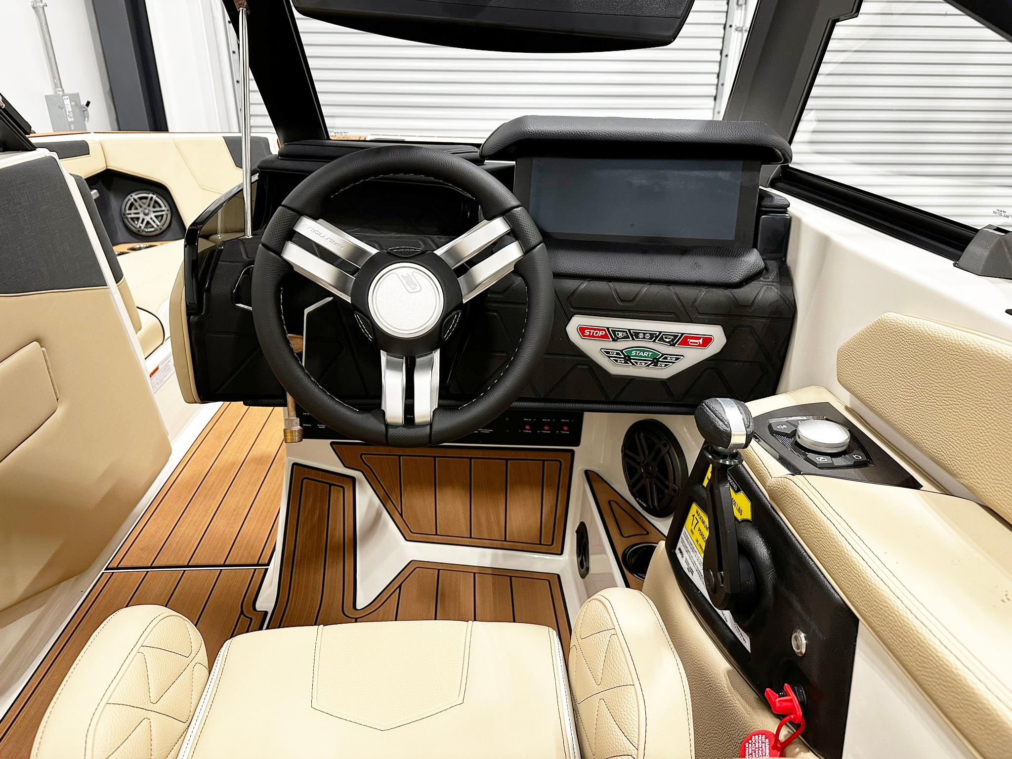 Interior of 2026 Nautique GS24 boat with modern steering and control panel.