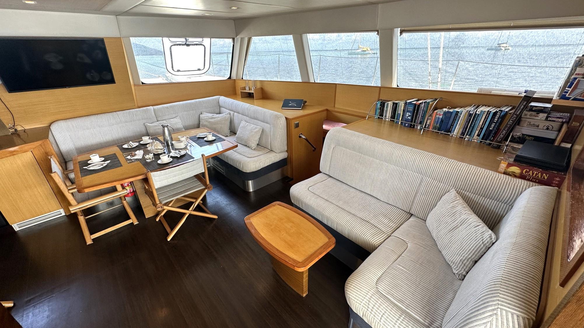 Luxurious Sunreef 62 yacht interior, featuring cozy seating, dining area, and panoramic windows, 2008 model.