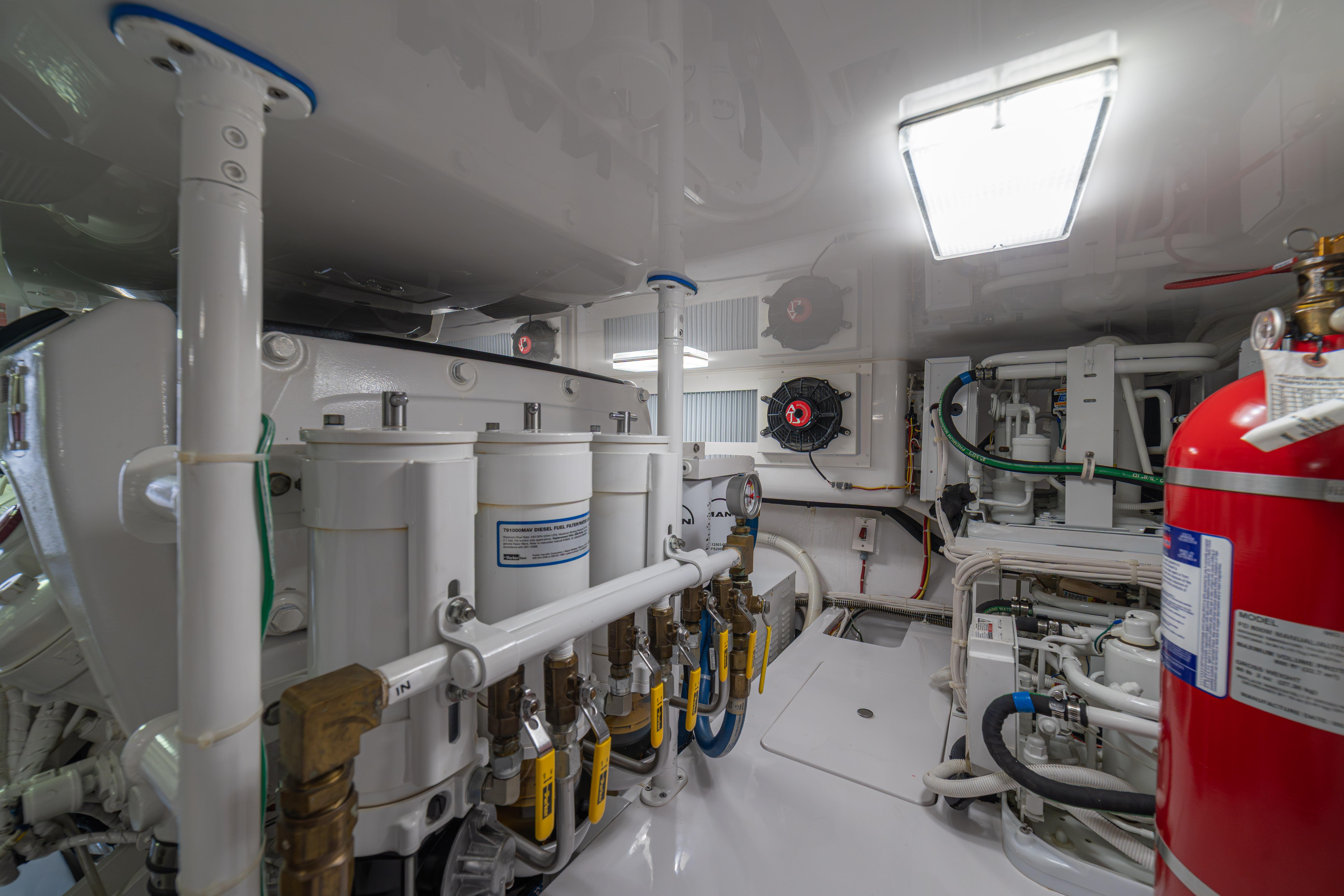 Engine room of 2024 Viking 48 Convertible yacht, featuring advanced machinery and safety equipment.