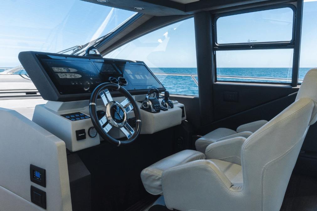 Luxurious helm of 2020 Azimut 60 yacht with modern controls and ocean view.