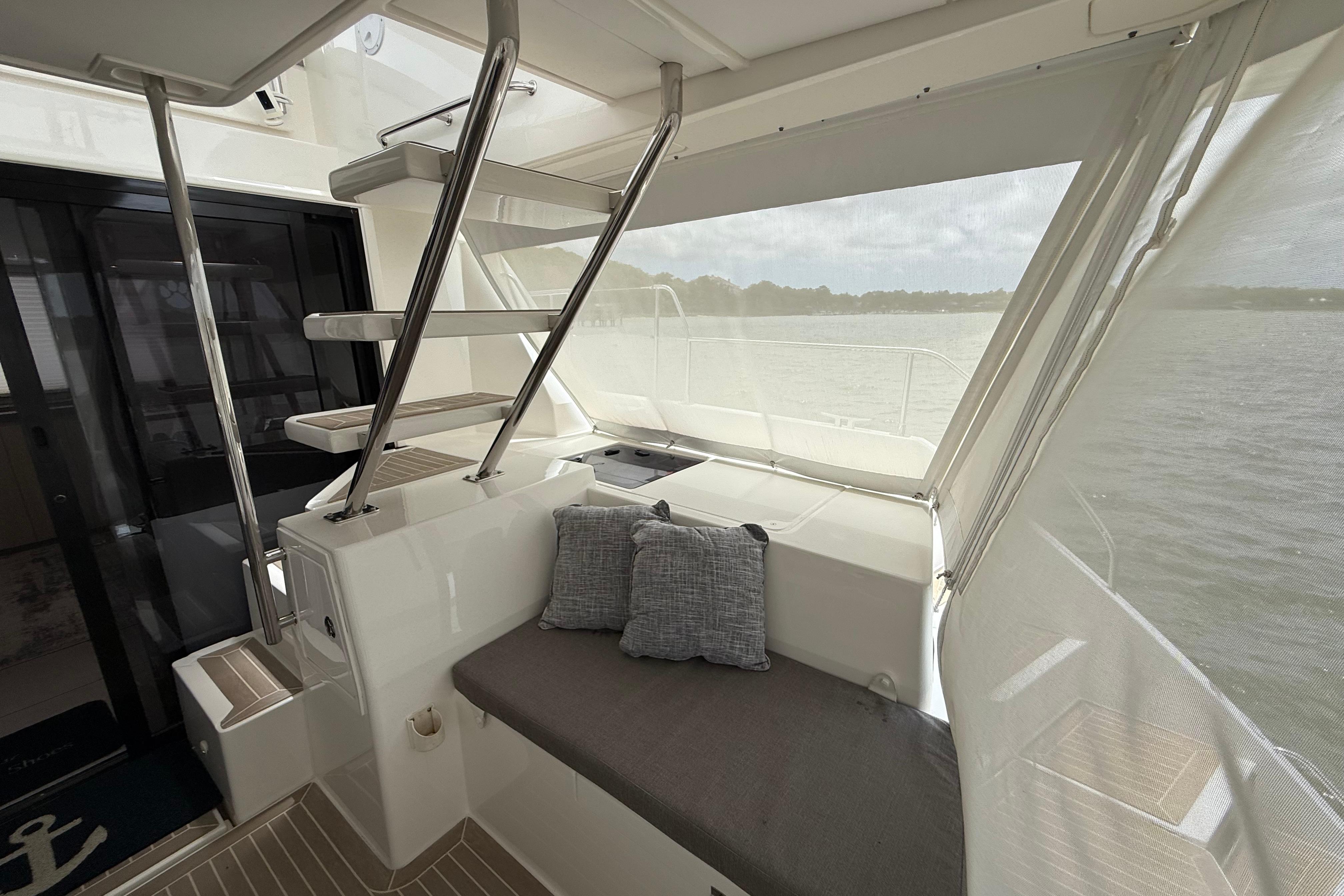 Interior of 2021 Leopard 43 Powercat yacht with seating and stairs, overlooking water.